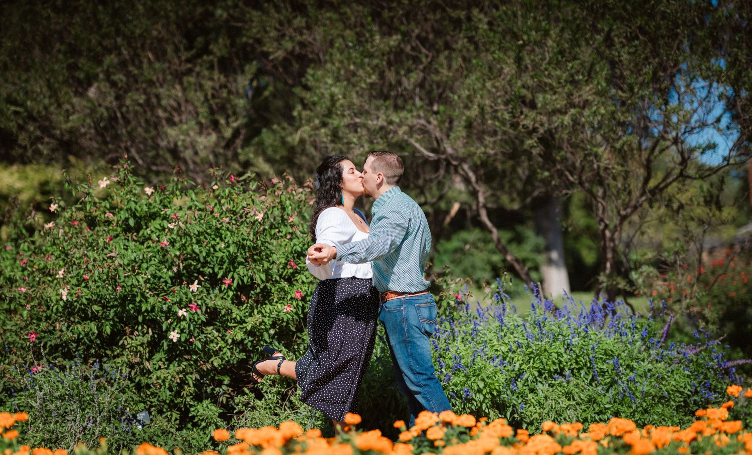 A series of photos showing couples embracing in a pumpkin patch during autumn with orange pumpkins in the foreground.