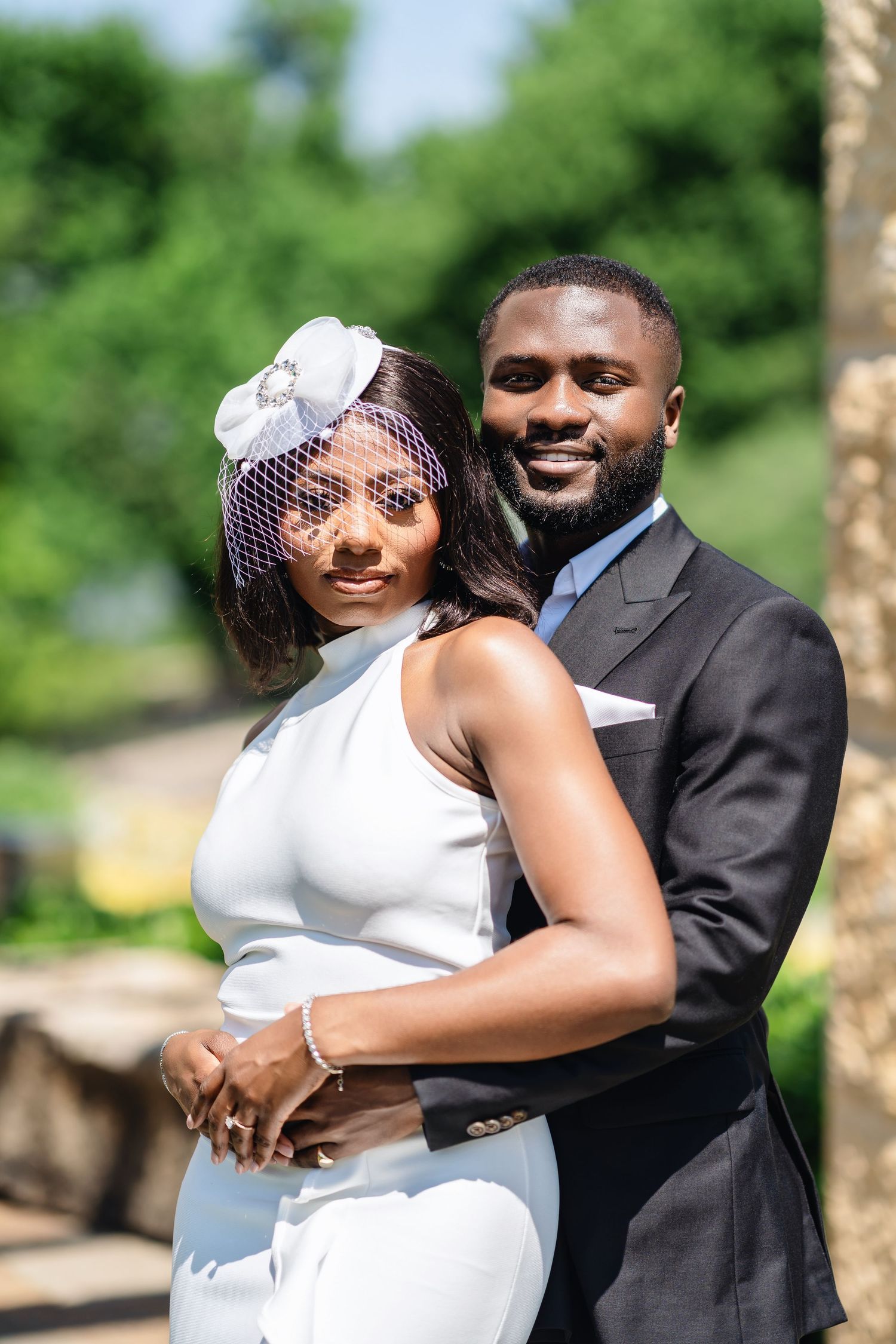 Wedding couple shares intimate moments in a sunny garden setting with beautiful natural lighting.