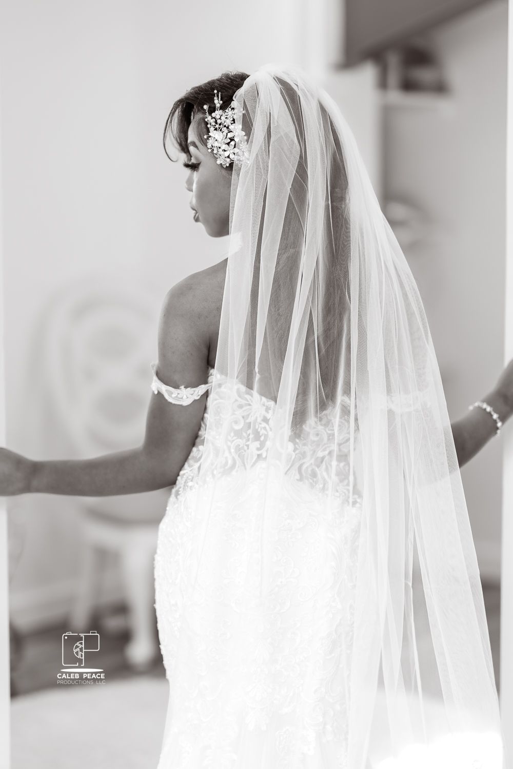 An elegant white wedding veil with lace detailing flows in a series of artistic black and white photos.