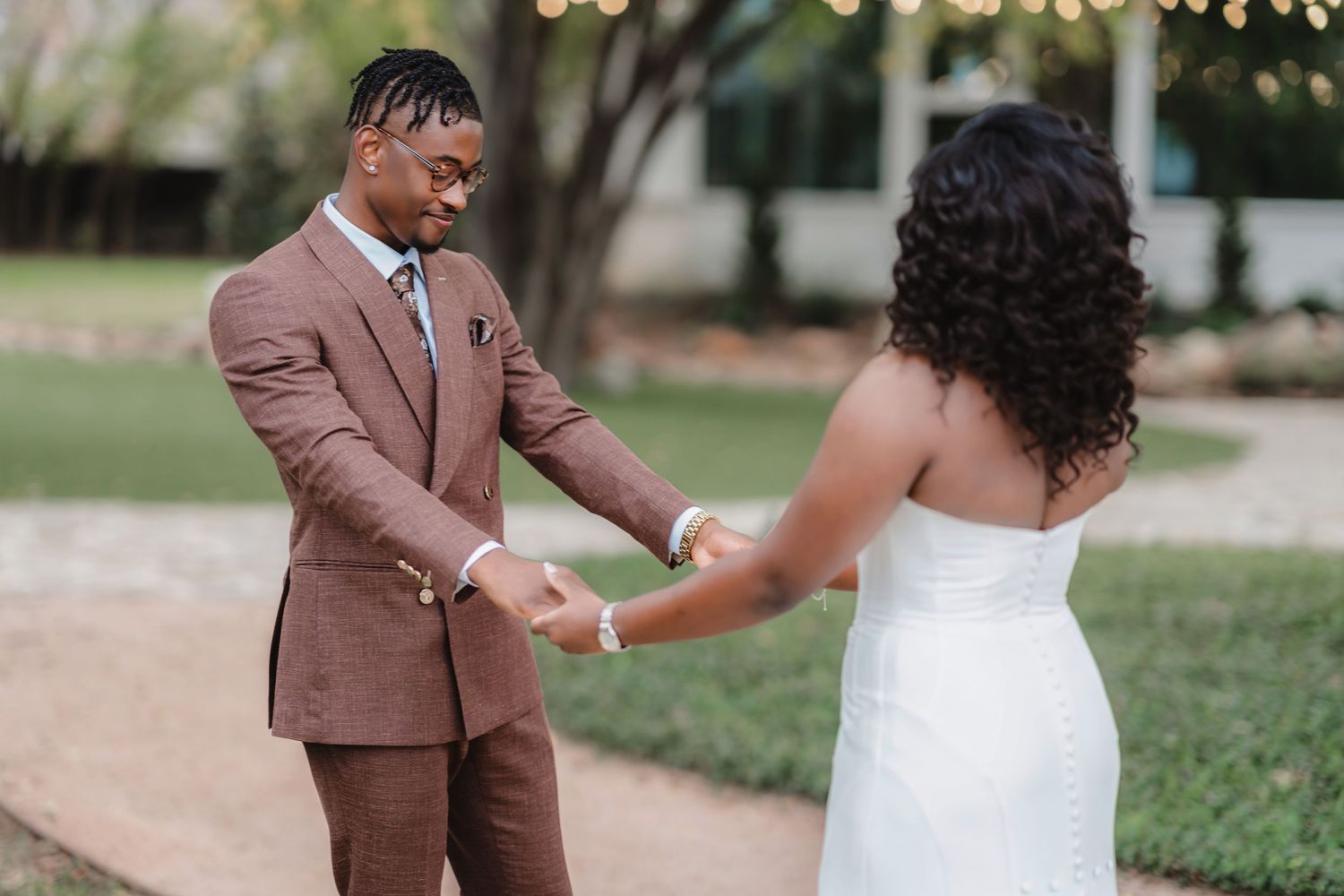 Couple shares their first dance outdoors during wedding celebration.