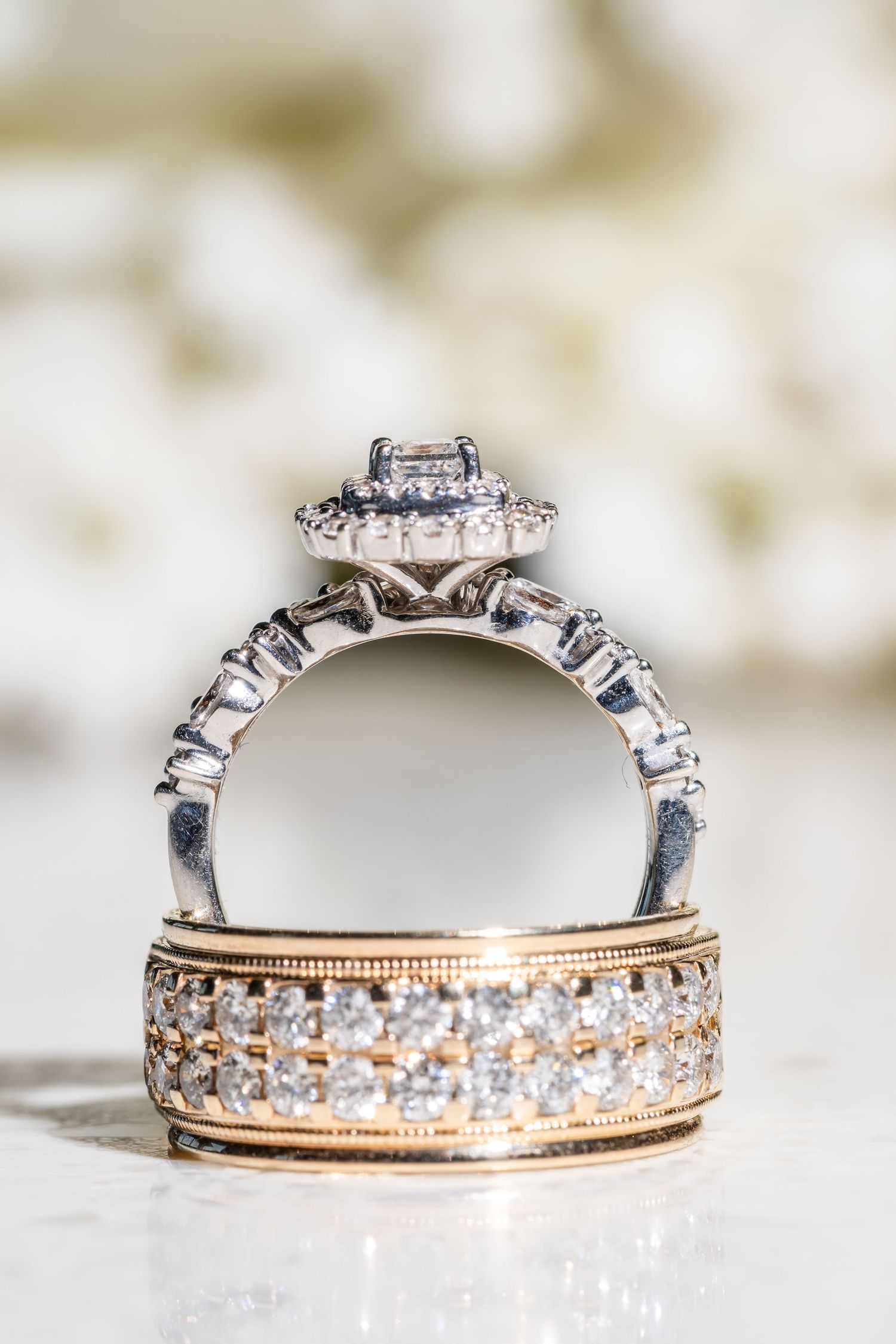 Elegant diamond engagement ring and wedding band set with rose gold and white gold details photographed in macro detail.