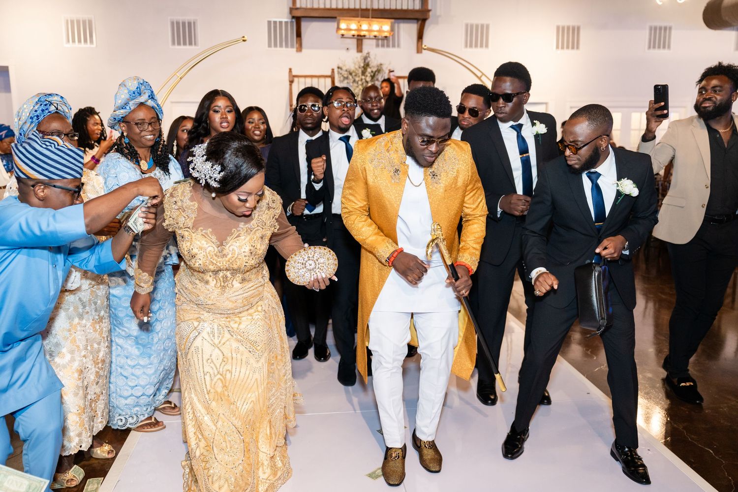 Wedding reception celebration with guests dancing and enjoying festivities in traditional attire.