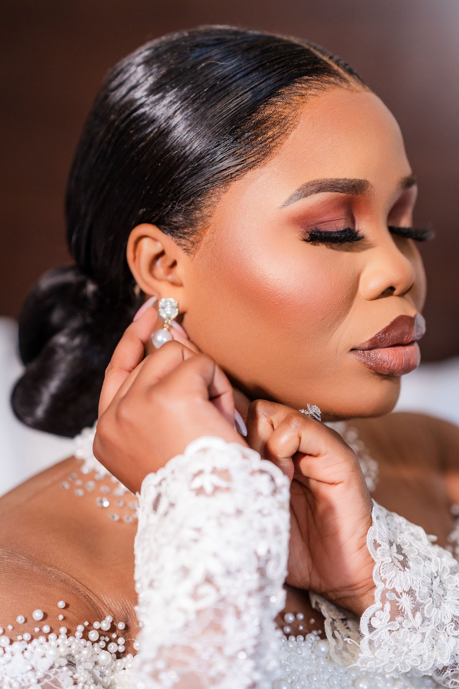 Close-up shots of bridal makeup and jewelry featuring delicate lace details and sparkling earrings.