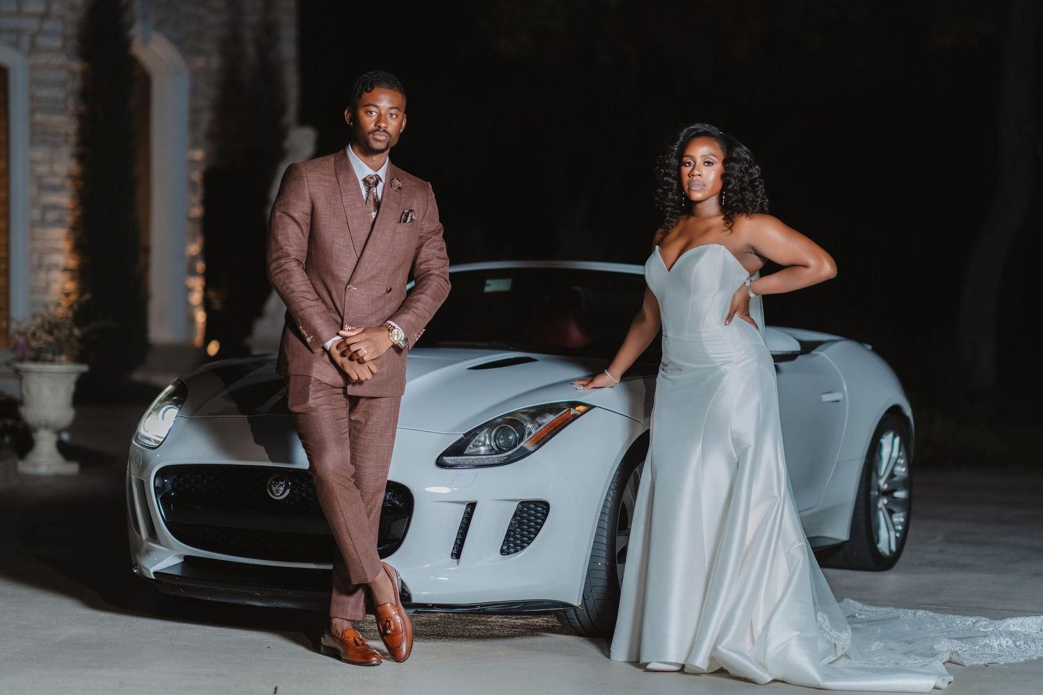 Stylish wedding photos featuring a couple posing with a luxury white sports car in dramatic lighting.