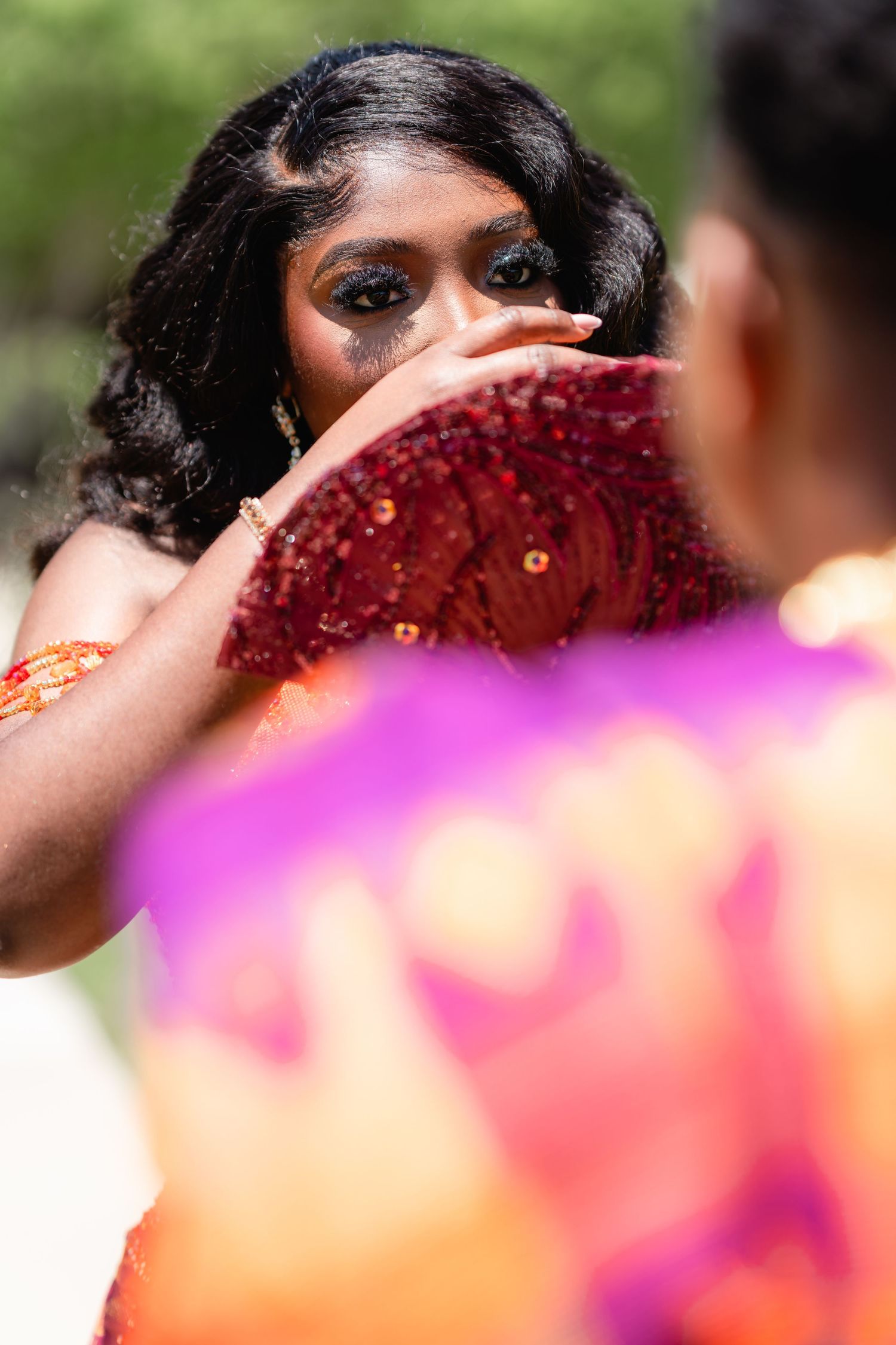 Close-up artistic shot of formal attire with orange and purple fabric details.