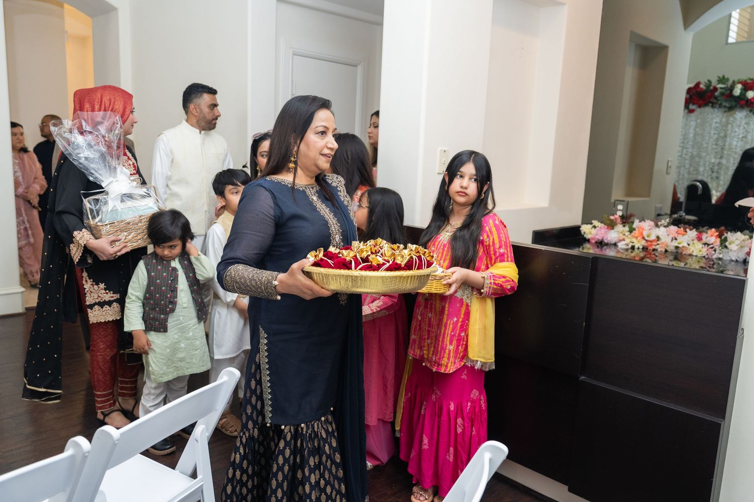 Wedding reception buffet setup with guests gathering around elegant food displays.