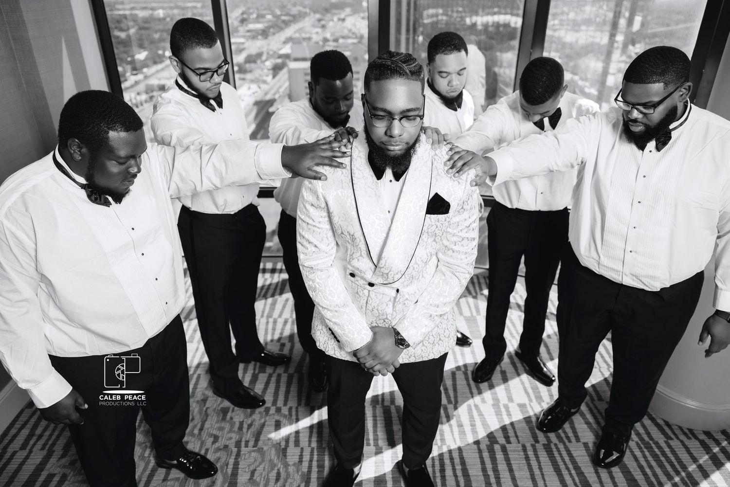 A black and white photo montage showing a group of people in formal attire interacting at what appears to be a social event.