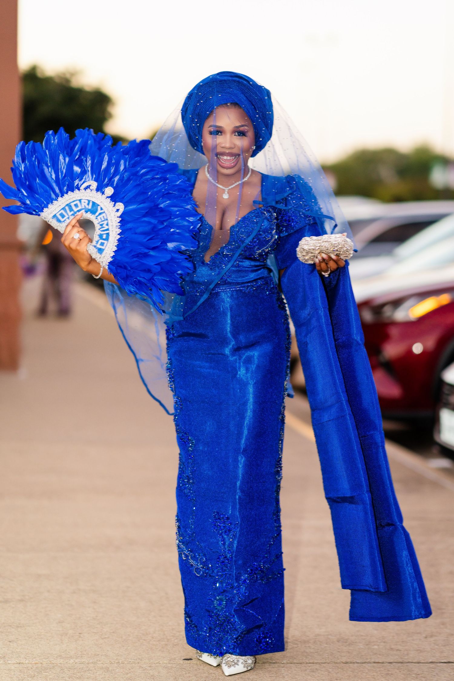 A series of photos showing someone in a vibrant royal blue traditional dress with matching headpiece and fan.