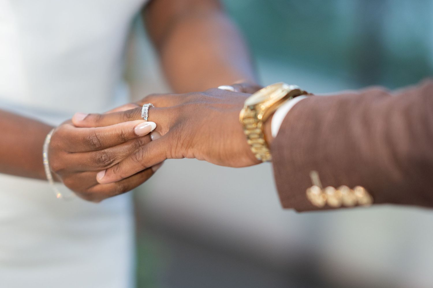 Close-up view of hands exchanging business cards in a professional setting.