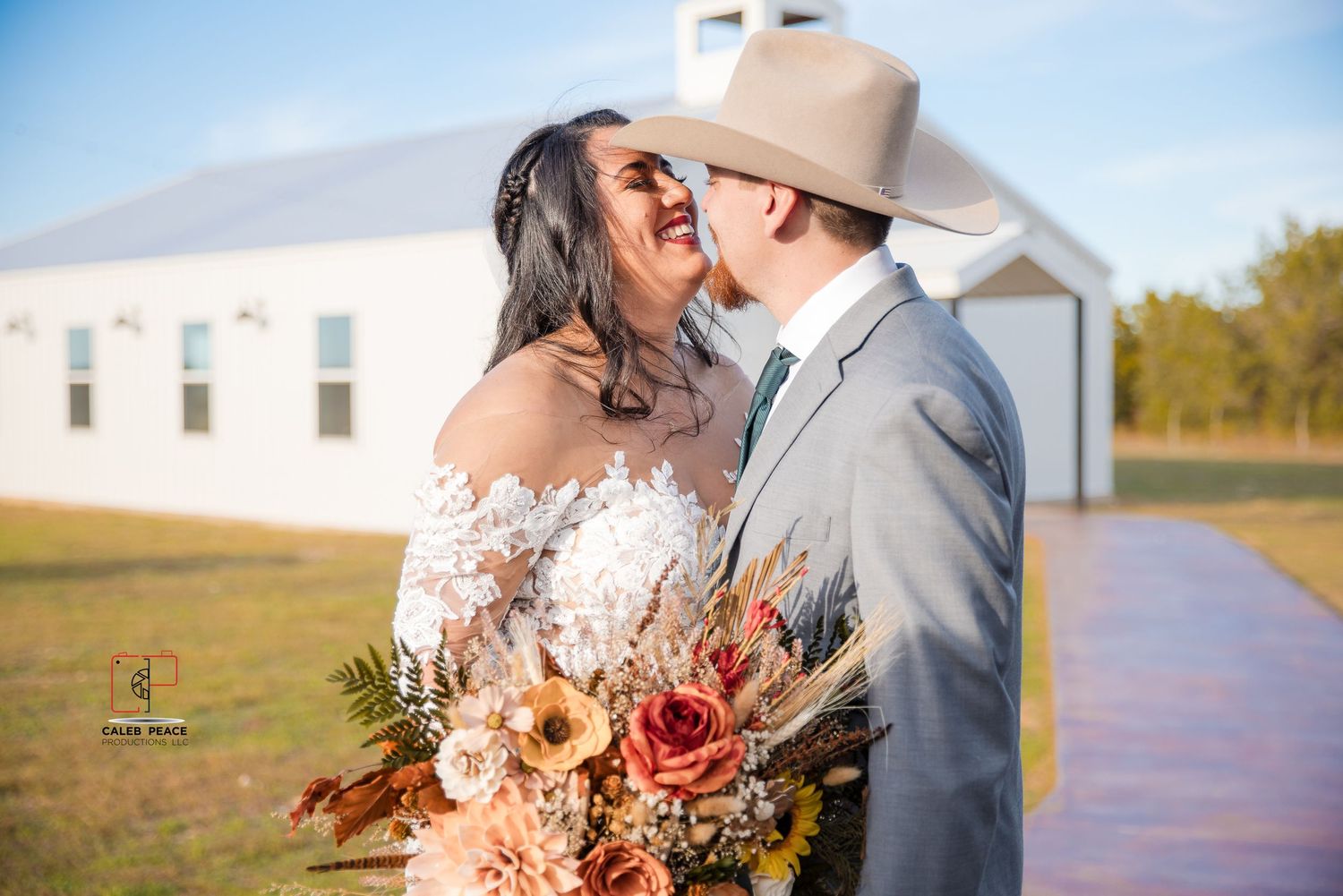Romantic outdoor wedding photos with rustic white chapel in background.