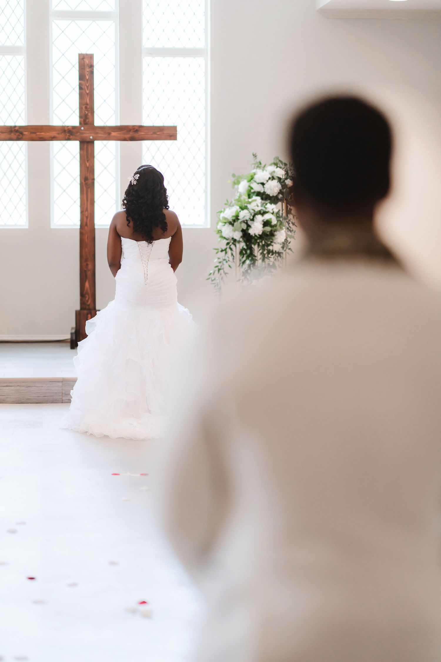 A sequence of ethereal bridal portraits in a bright white church interior with a wooden cross and floral arrangements.