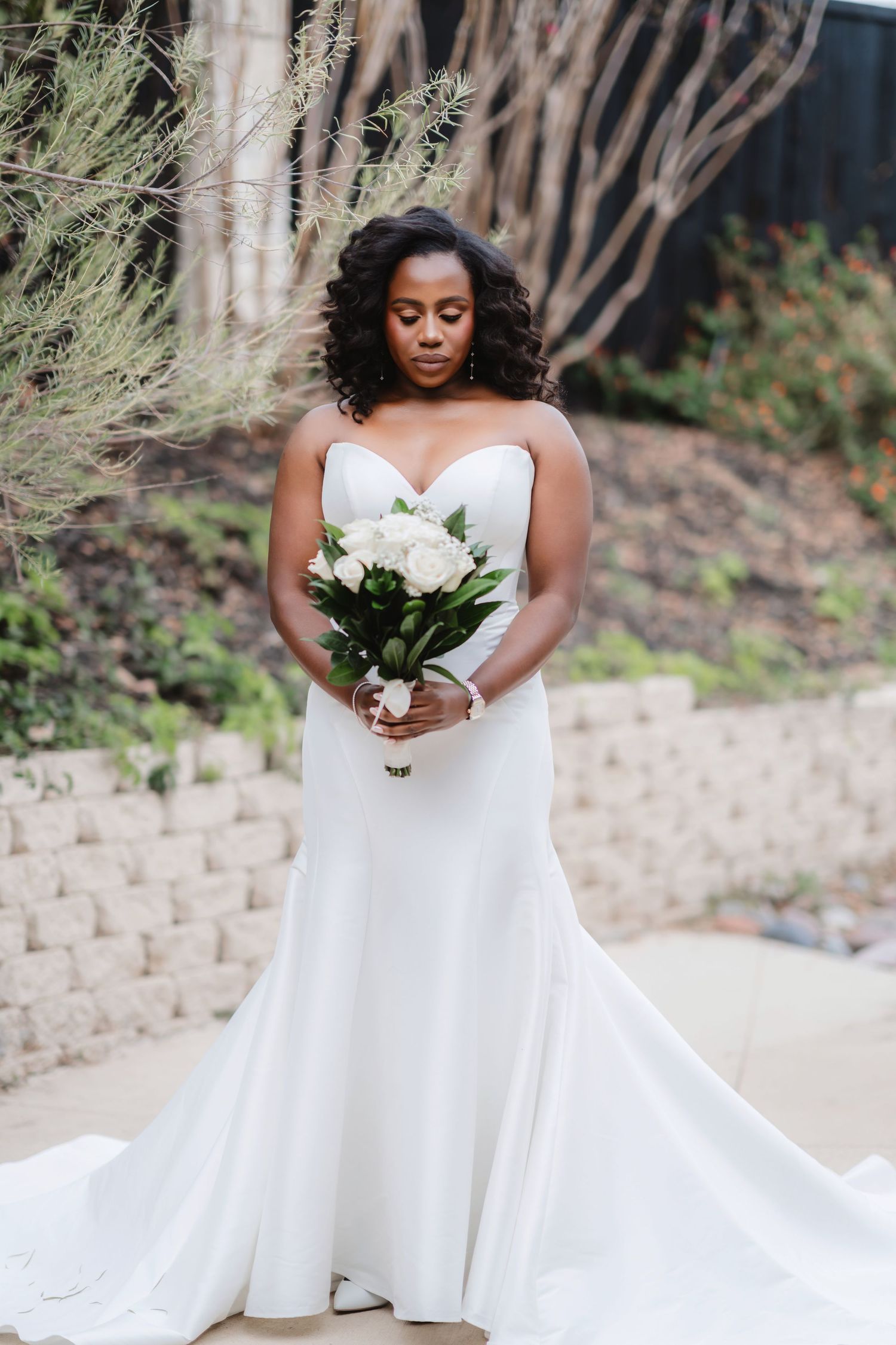 A stunning white wedding dress with a sweetheart neckline and flowing train is displayed in multiple angles.