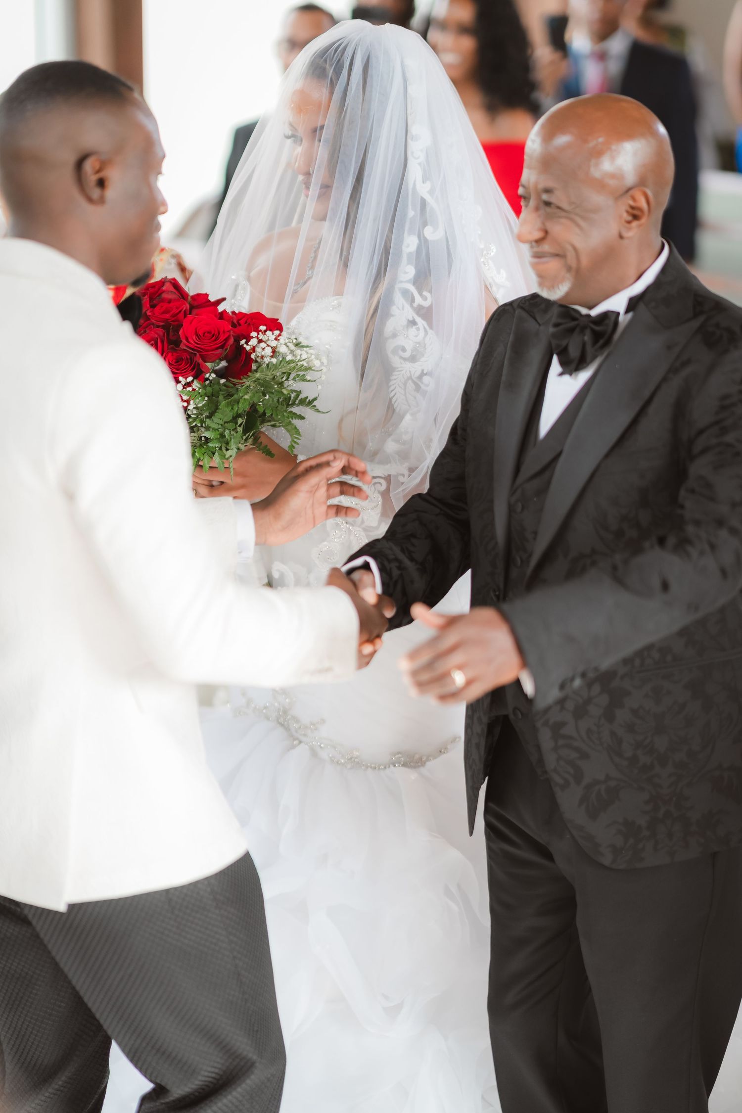 Wedding ceremony candid moments with bride in flowing white gown and attendants in formal wear.