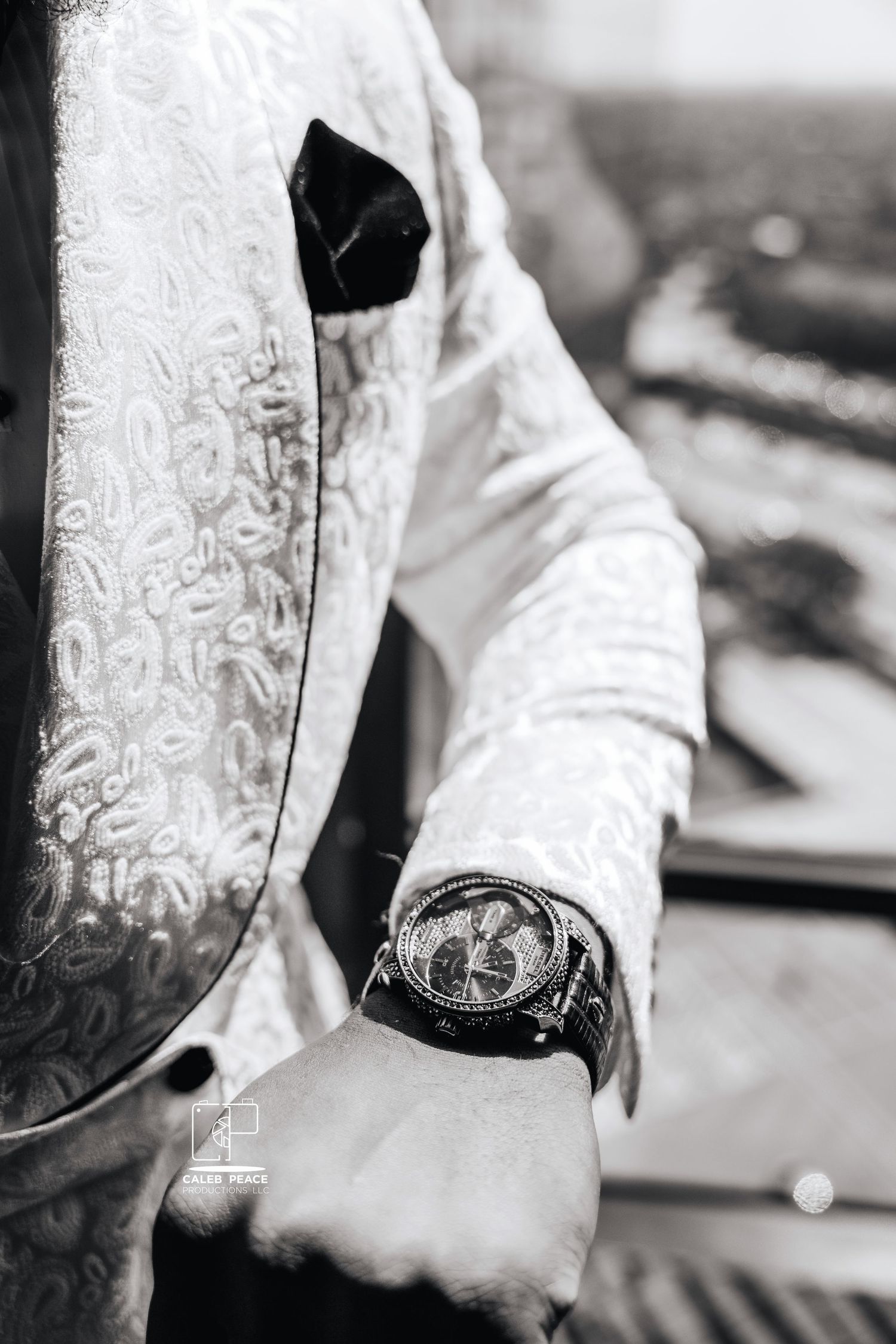 Close-up details of ornate white lace and embroidery on formal wedding attire.