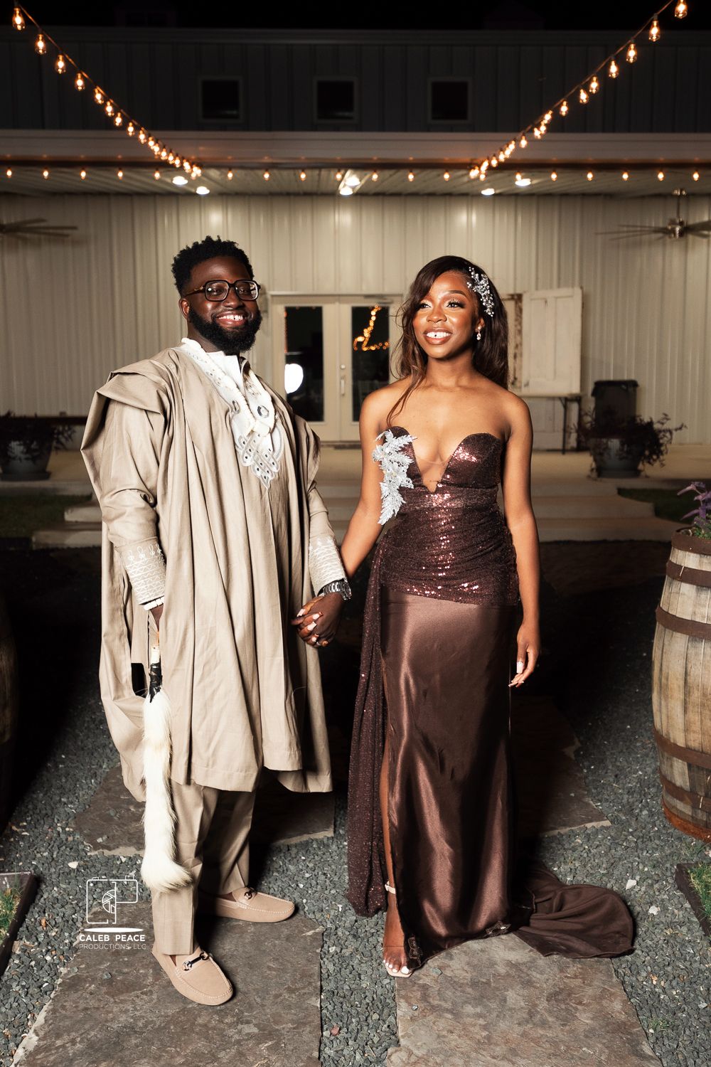 Wedding couple poses together in an indoor venue with string lights creating a warm ambiance.