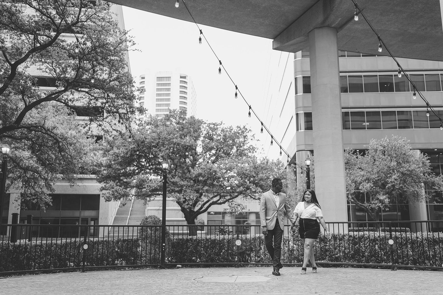 Black and white photo series showing different views of a modern urban park with walkways and architectural elements.