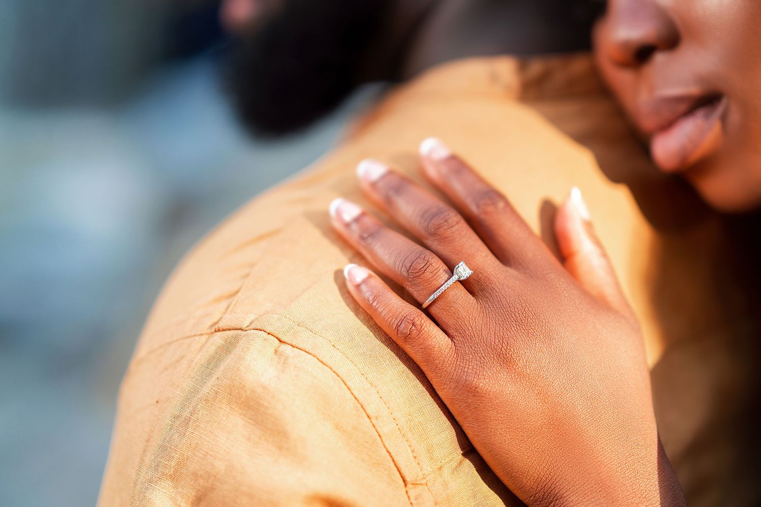 Close-up shot of a couple sharing an intimate moment outdoors.