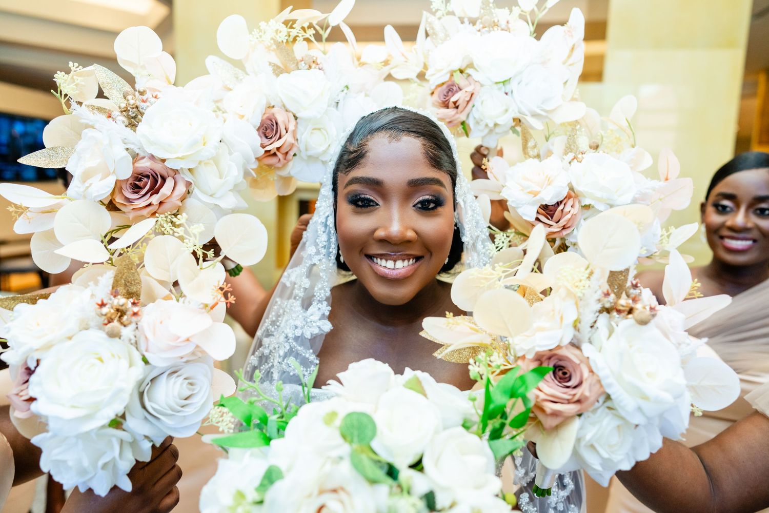 A joyful wedding moment captured with stunning white and pink floral arrangements framing the scene.