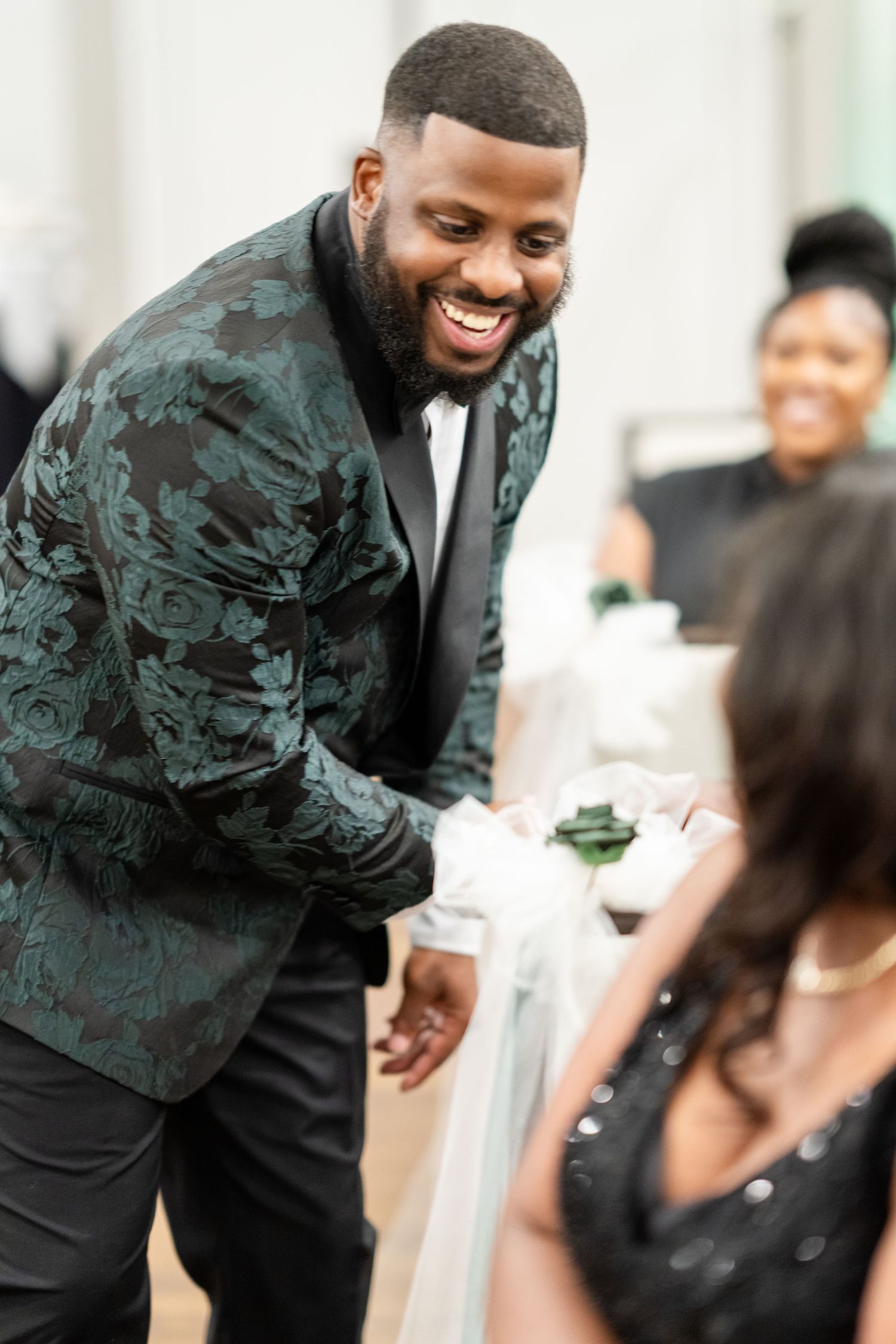 Candid reception moments showing joyful interactions in a bright indoor venue.