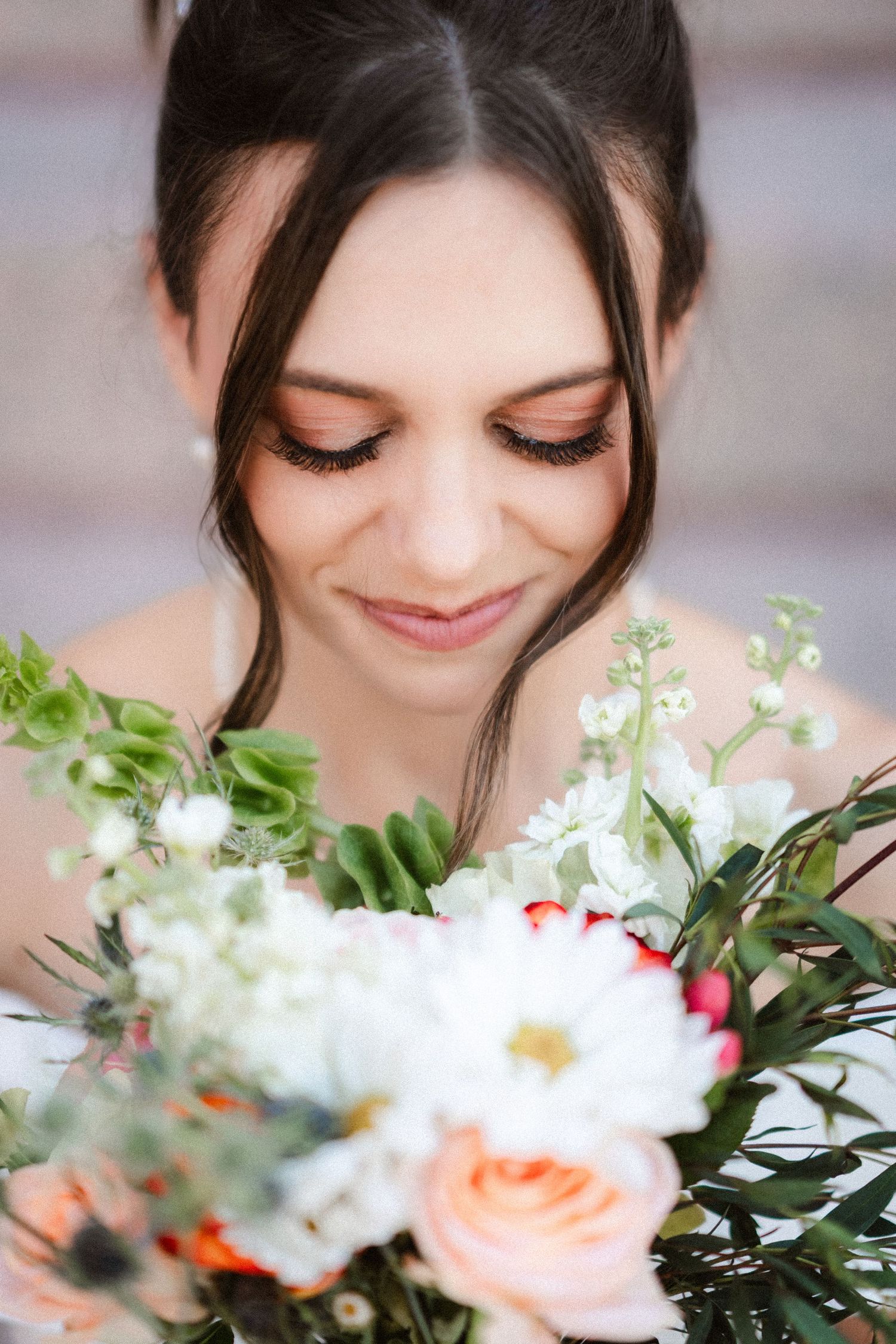 Wedding bouquet closeups featuring delicate peach roses and white flowers with greenery.