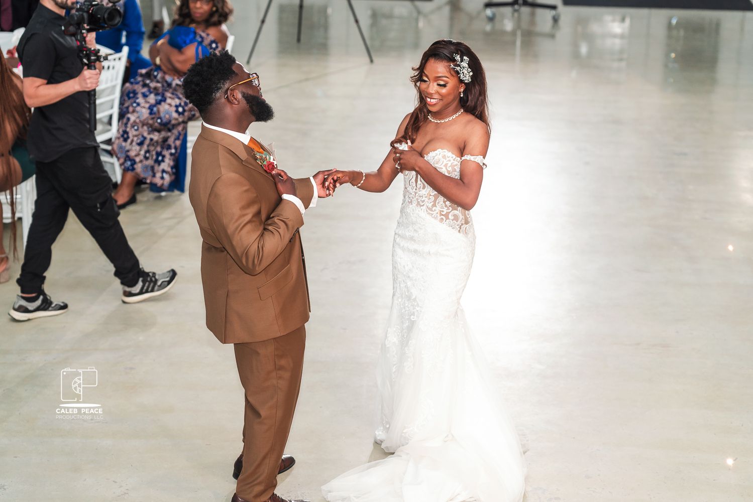 Couple dancing together in formal attire at an indoor event venue.