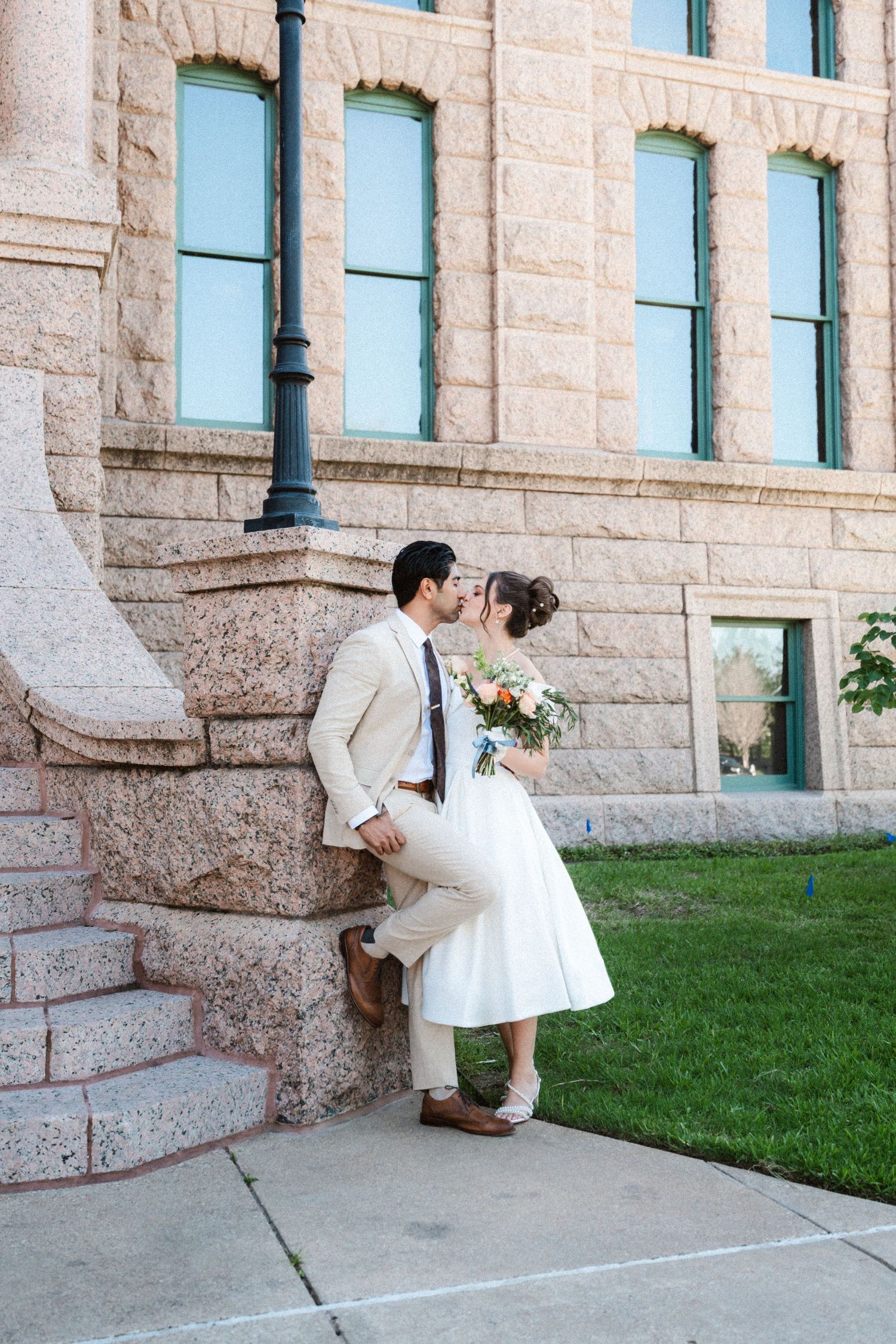 Artistic wedding photo sequence capturing romantic moments against a stone building exterior.