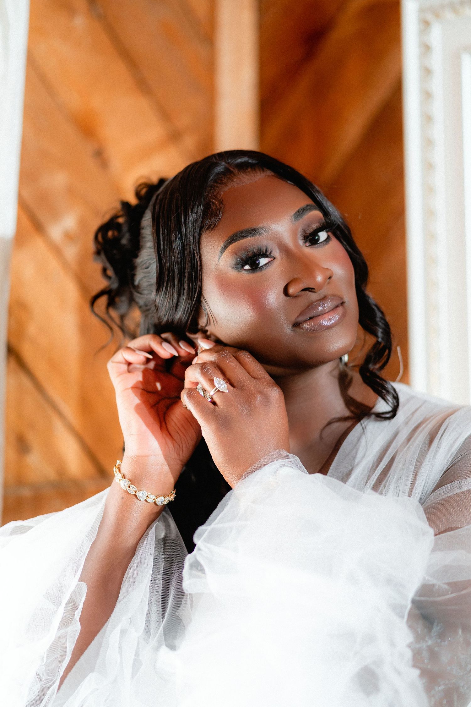 Close-up bridal portrait showing delicate white veil and elegant makeup.