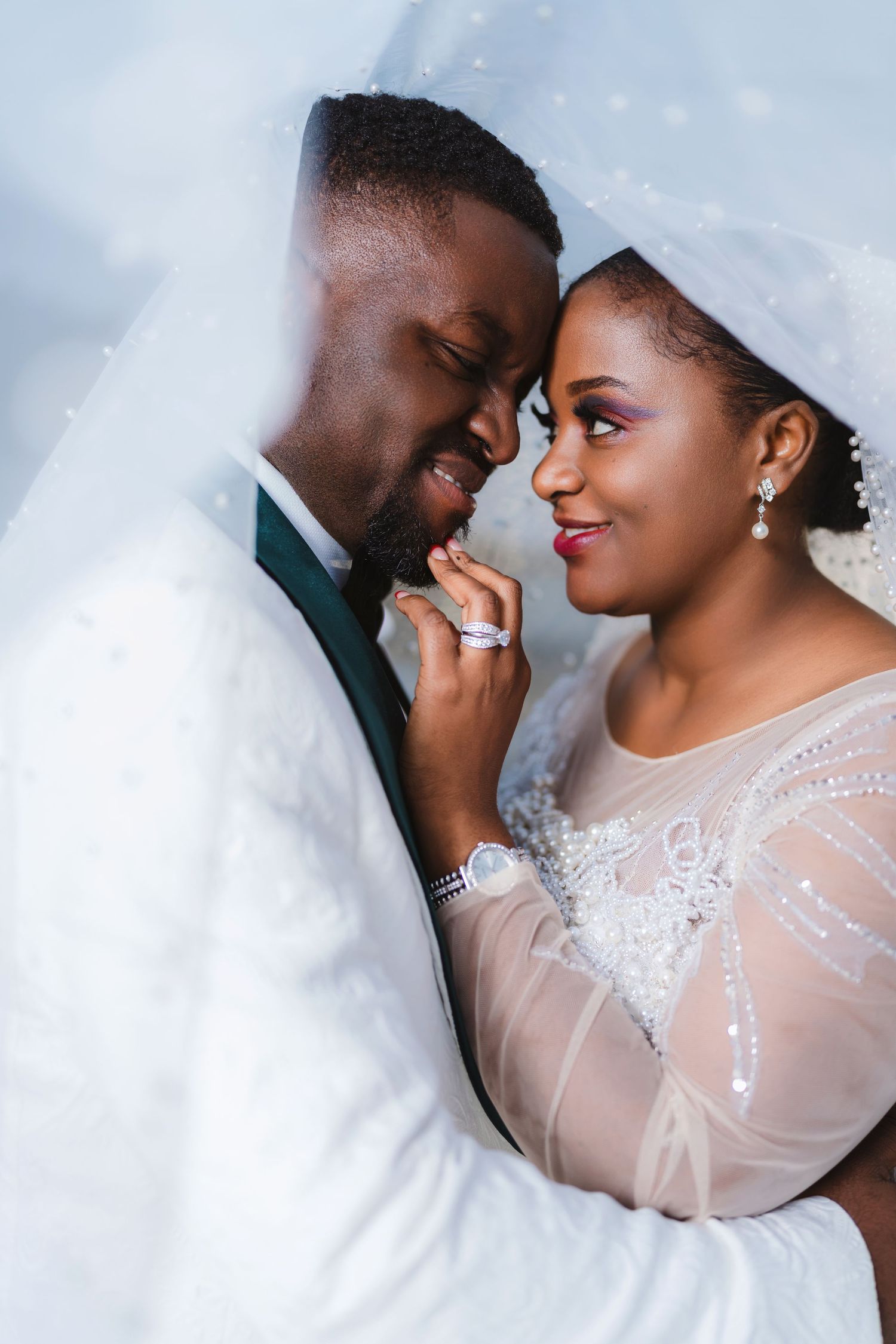 Intimate wedding portrait series showing tender romantic moments between newlyweds against a light background.