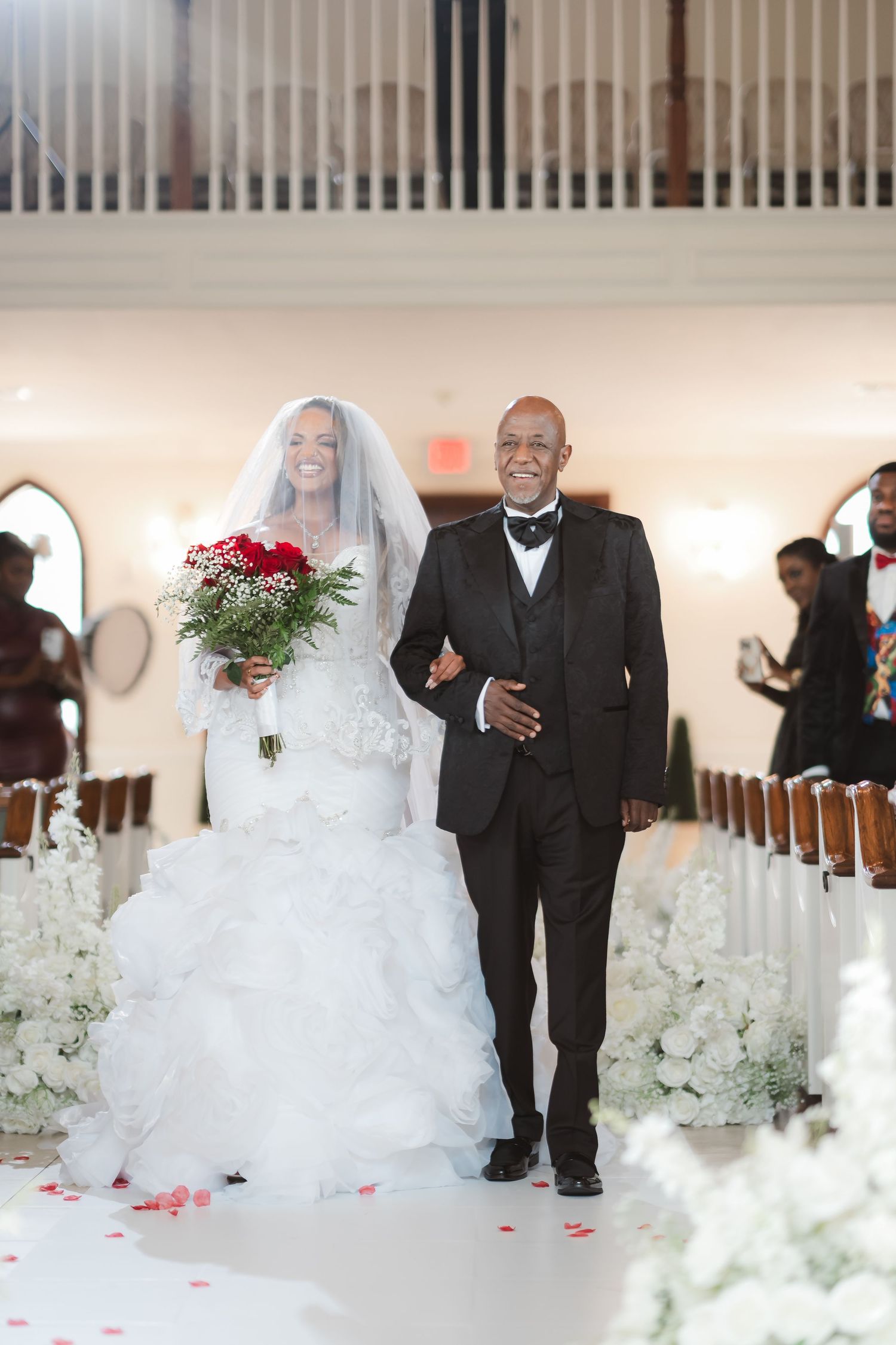 Wedding ceremony sequence showing bride in flowing white gown walking down church aisle with escort.