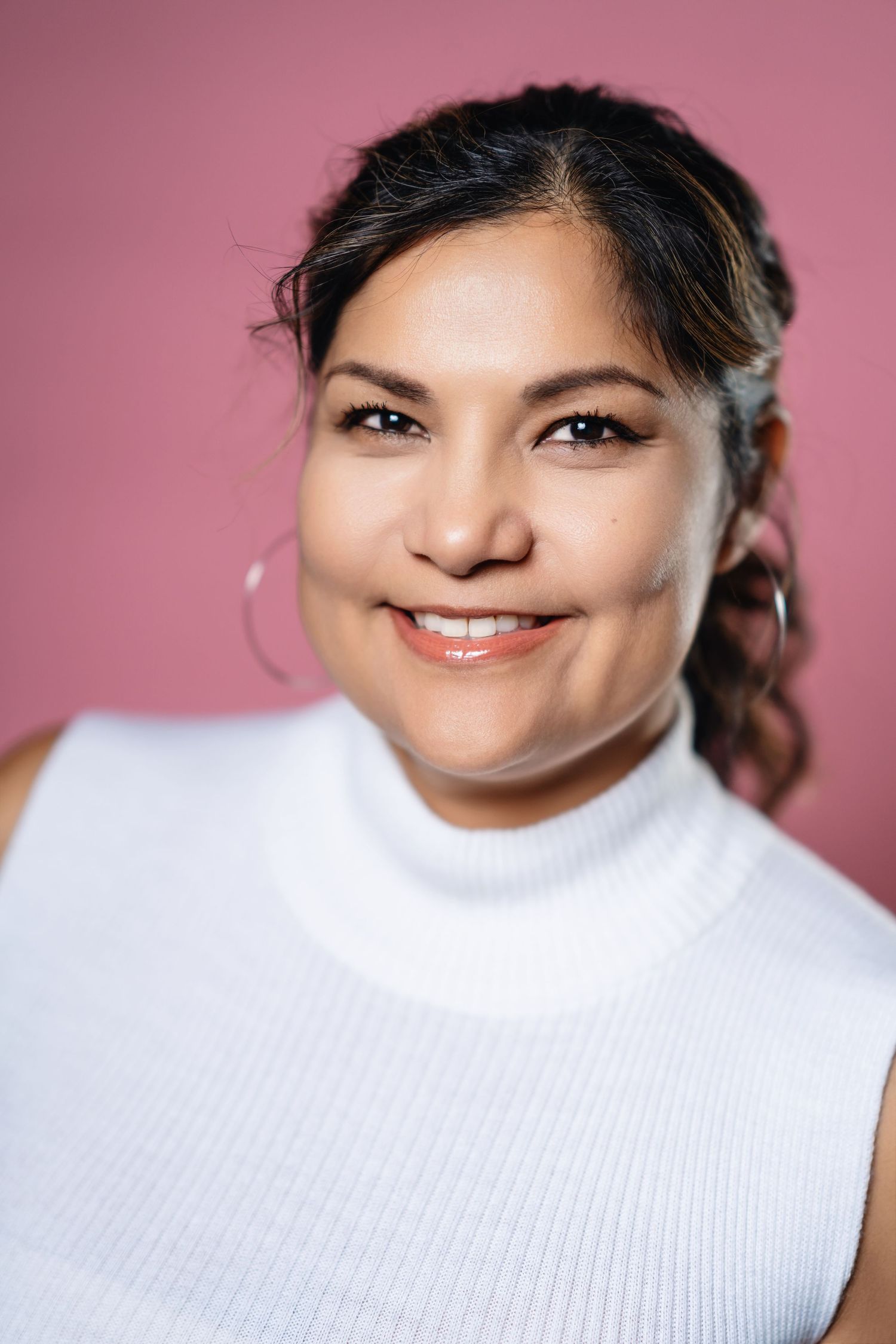 Close-up portrait series showing different expressions against pink background.