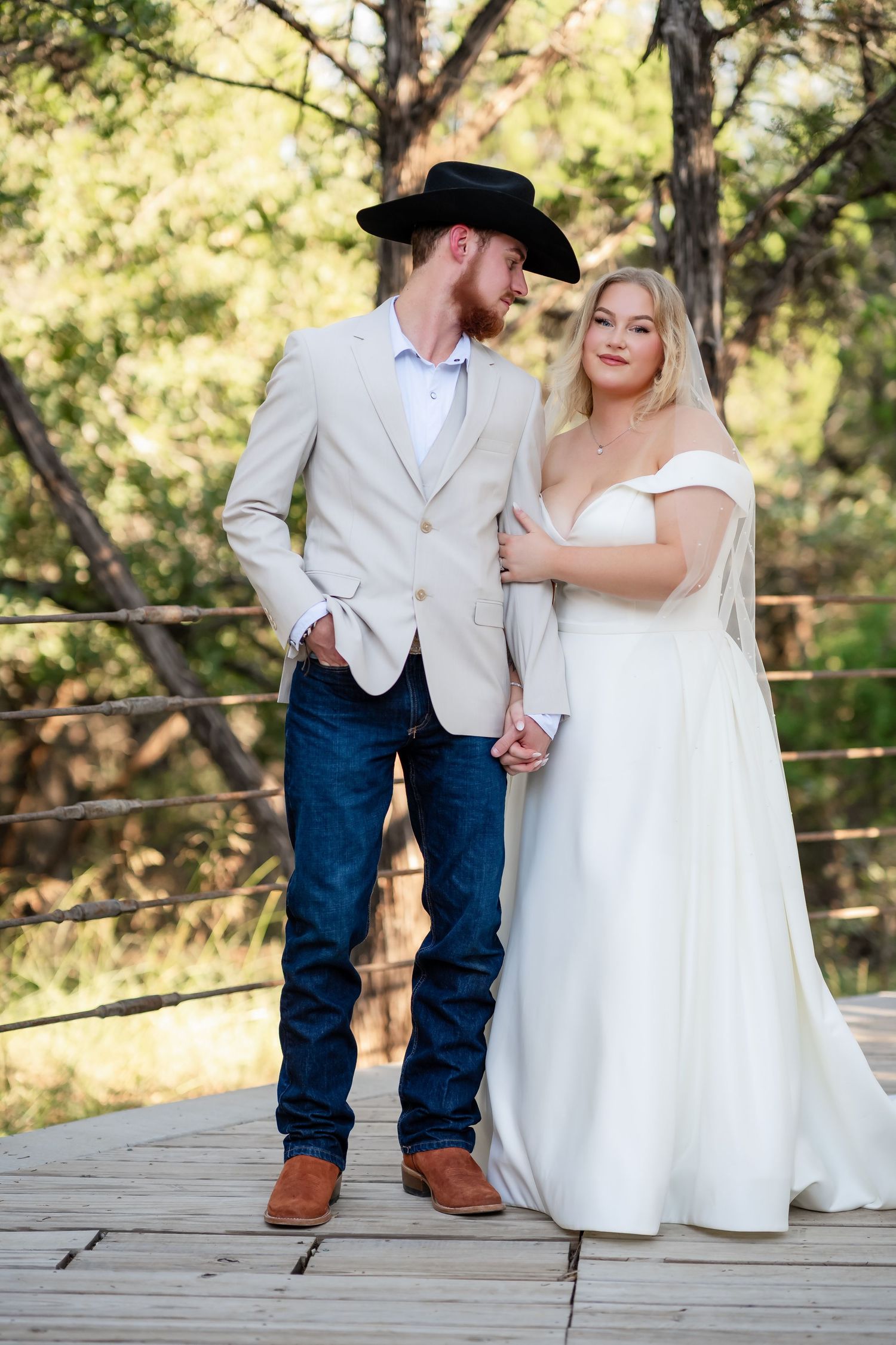 Wedding couple shares intimate moments on rustic wooden deck.
