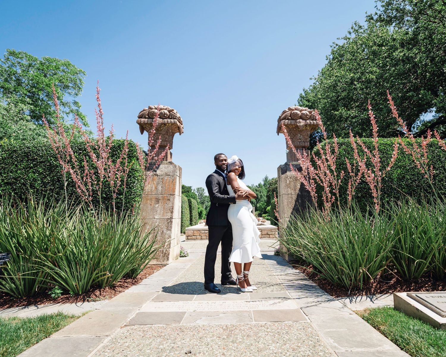 A series of wedding photos showing a couple walking along a garden path with pink flowering plants.