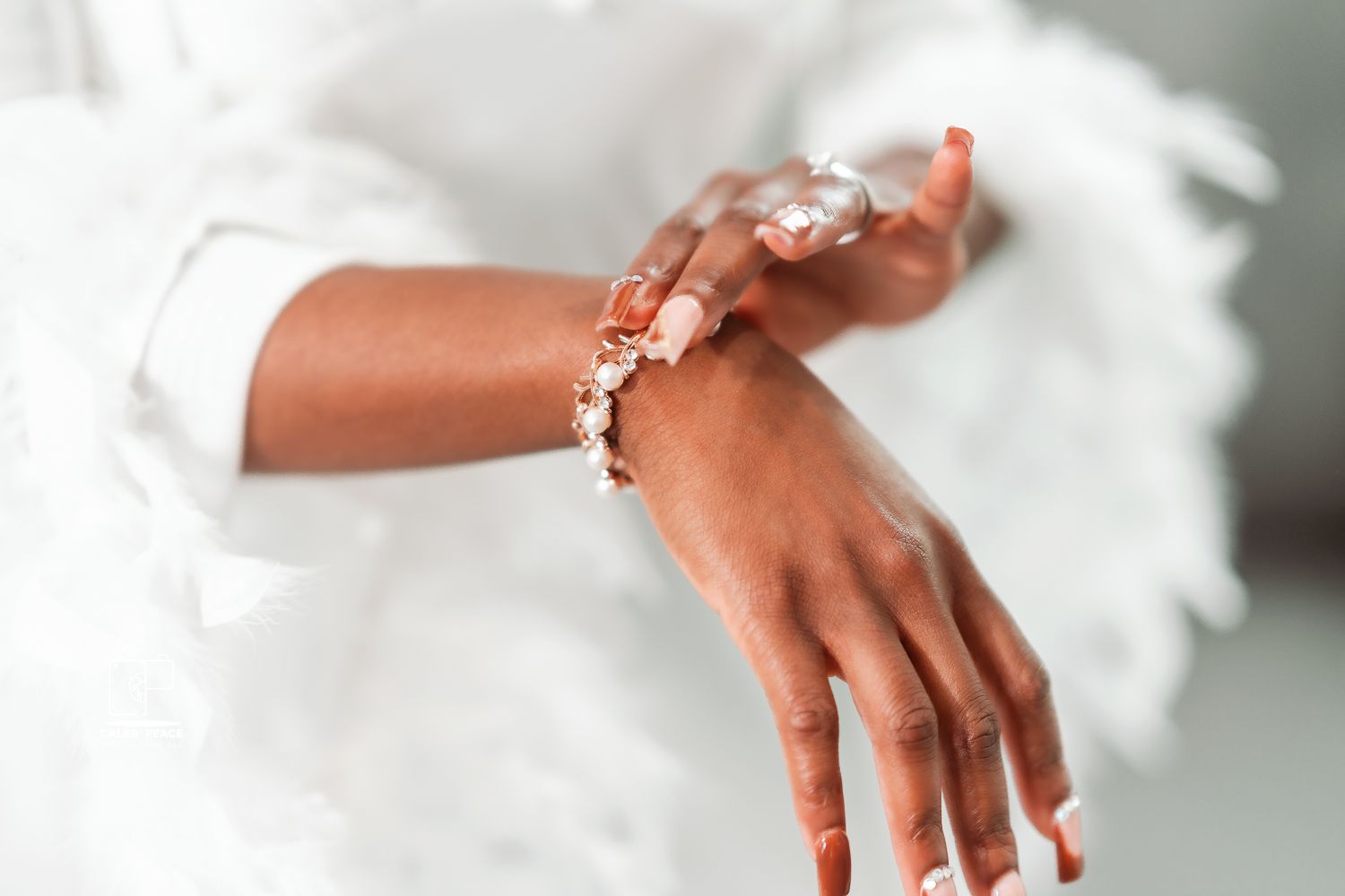 Close-up details of bridal jewelry and accessories against soft white background.