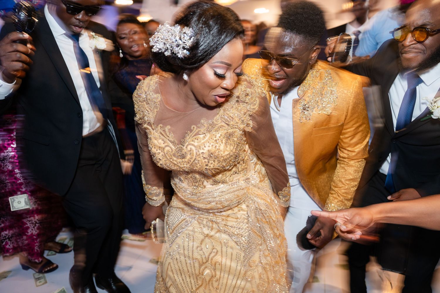 Lively wedding reception dance floor with guests in colorful attire.