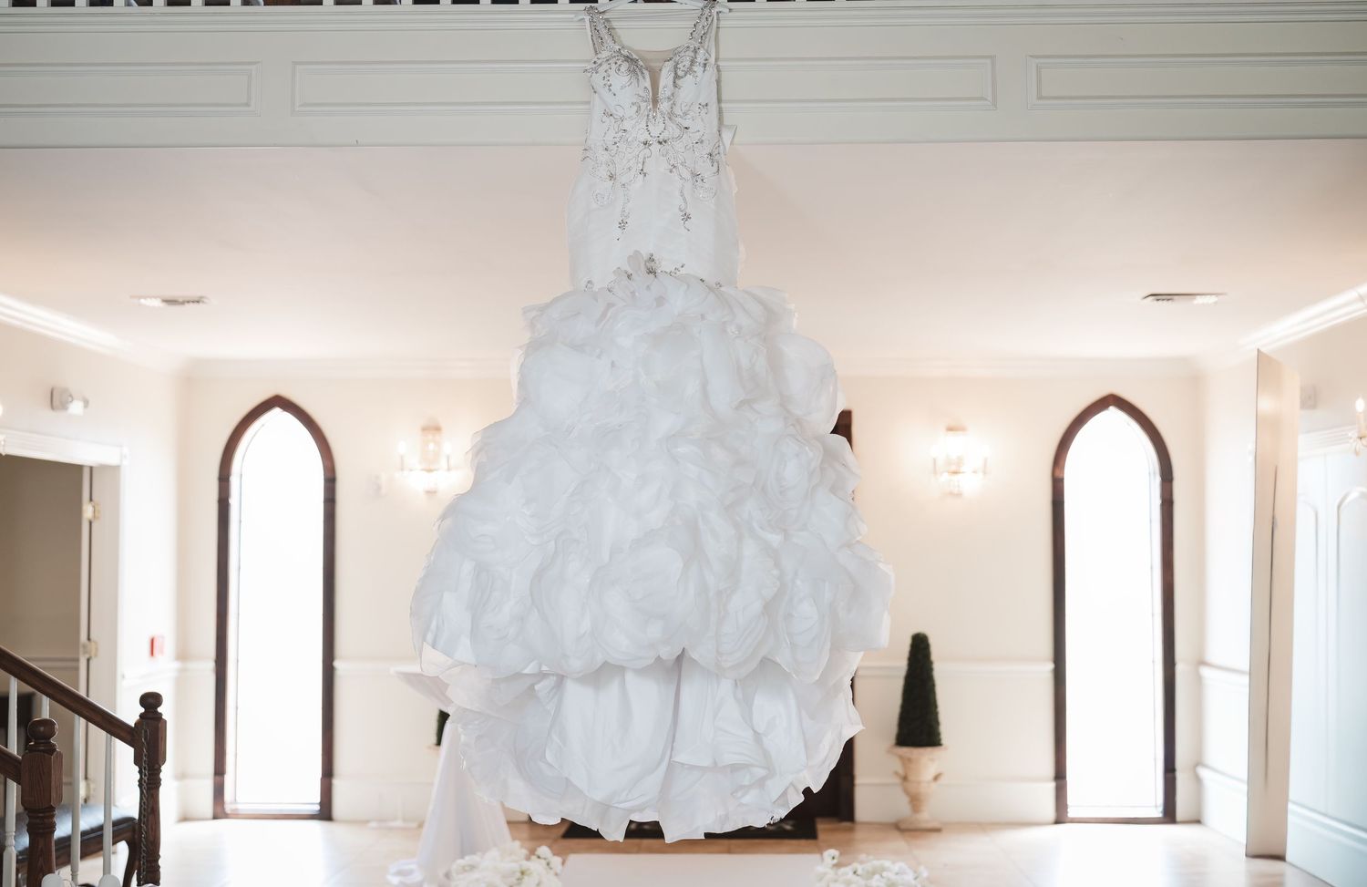 Interior shots of an elegant white wedding venue with arched windows and clean modern design.