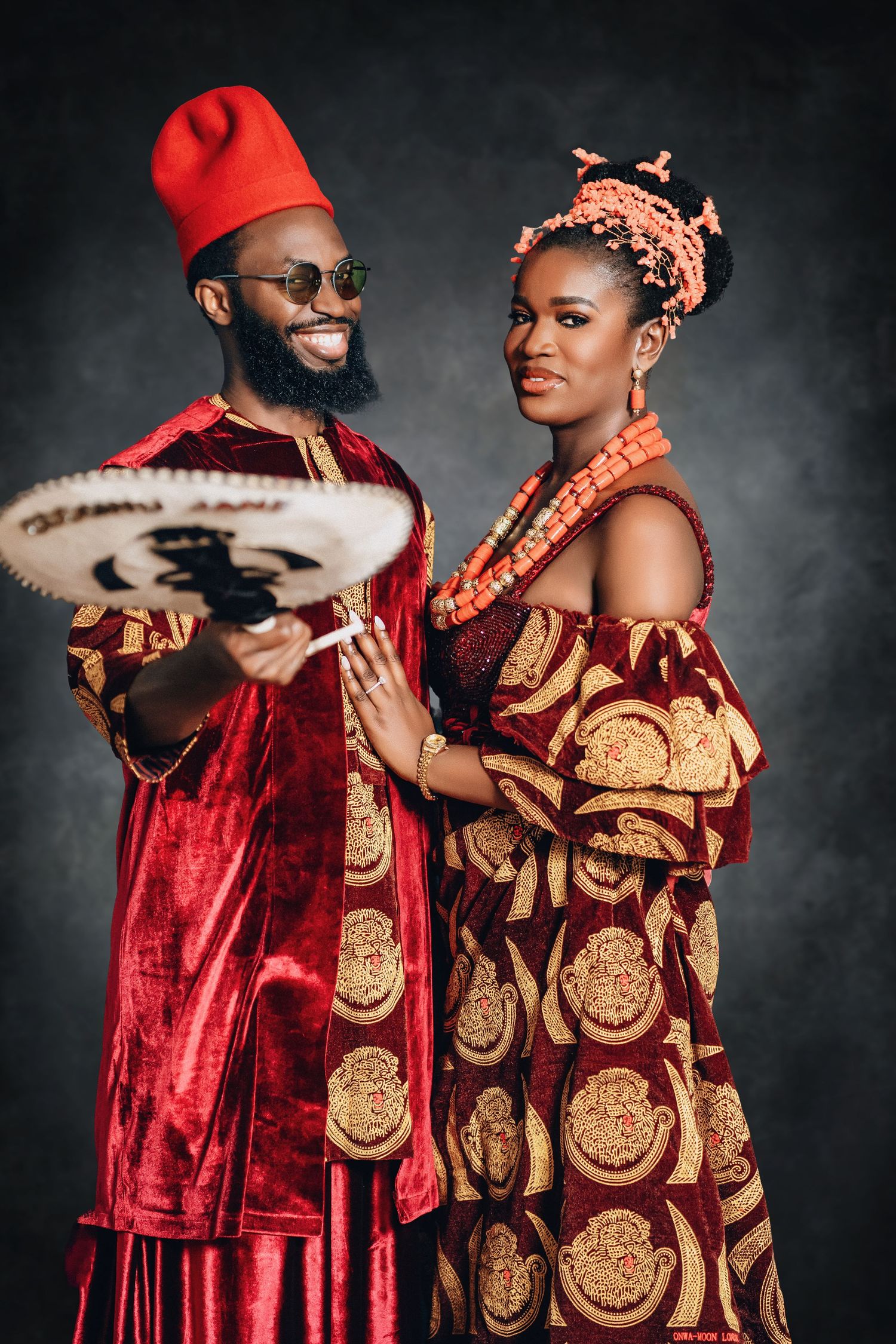 A series of romantic poses in traditional Nigerian wedding attire featuring red velvet and gold patterned fabrics.