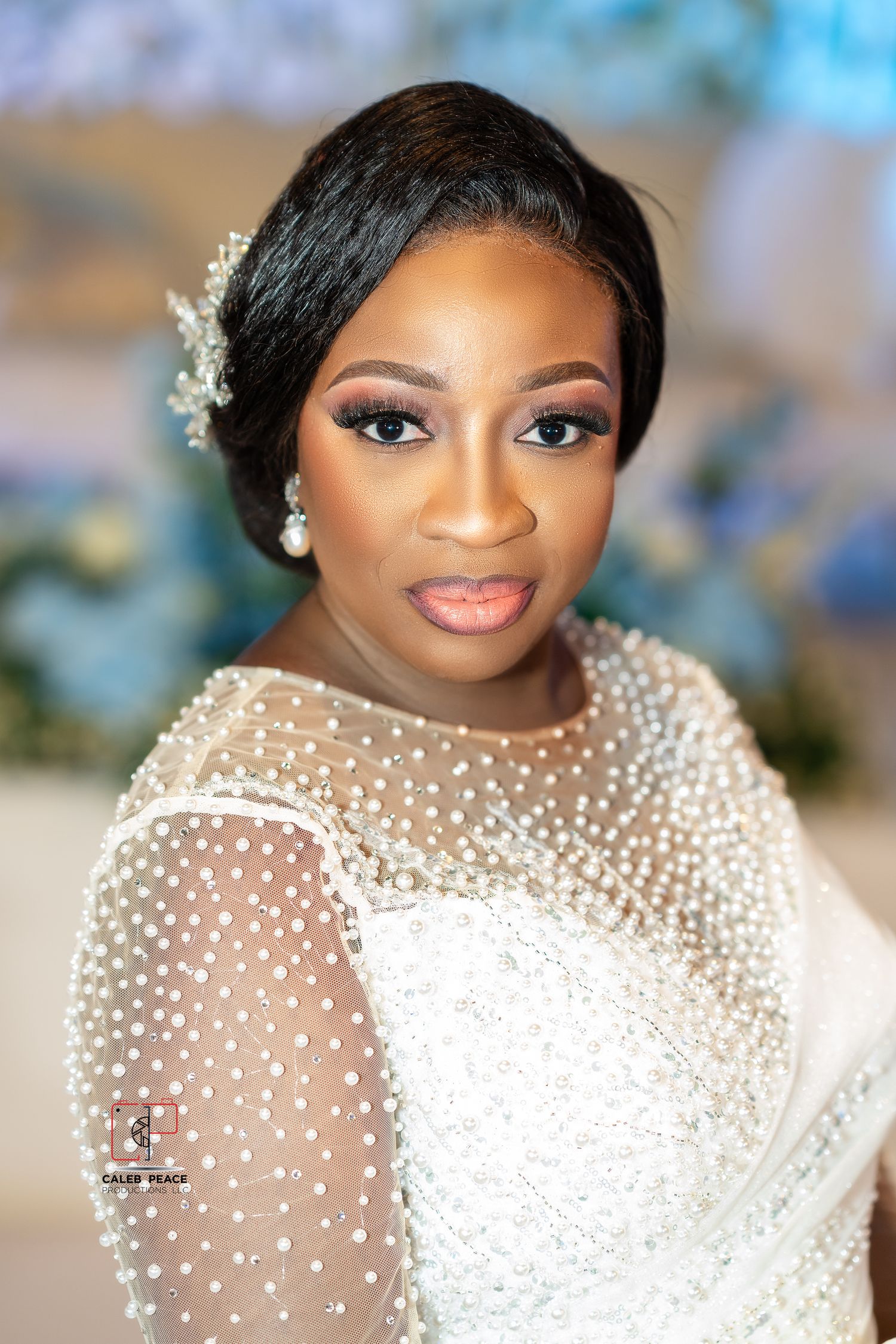 Close-up portraits of a bride wearing a sheer white gown adorned with delicate pearl embellishments and elegant makeup.