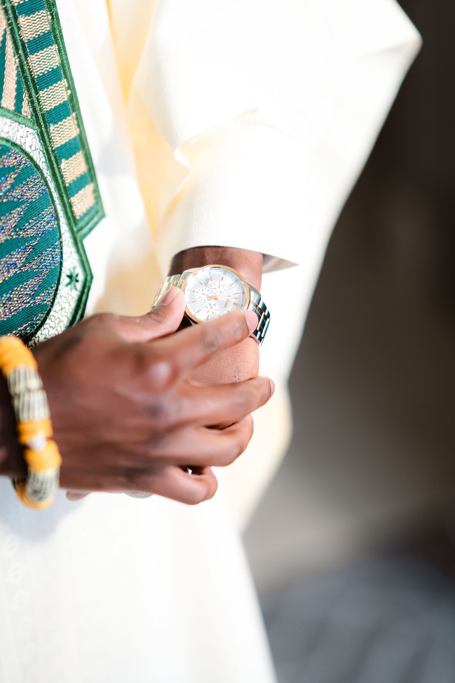 Close-up shot of hands holding decorative paper money fans against a dark background.