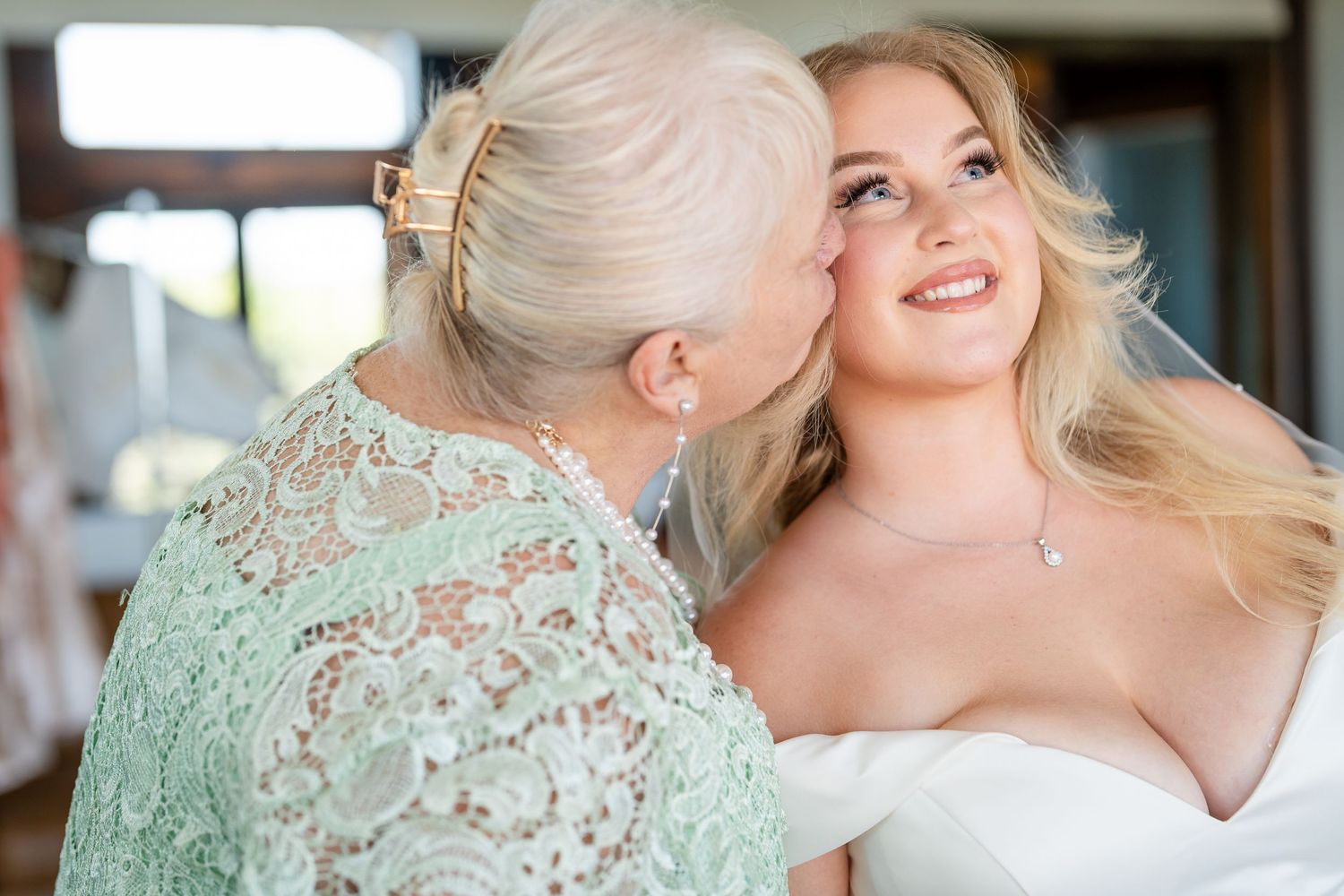 Tender moments captured during wedding day preparations in soft natural light.
