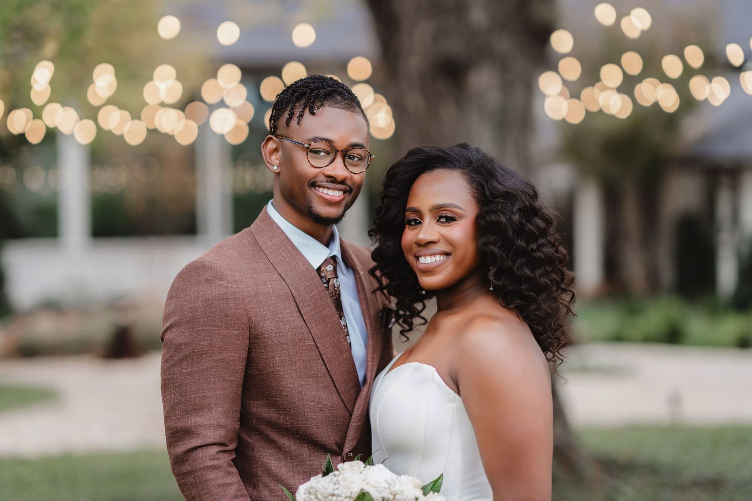Wedding celebration under string lights with a romantic outdoor ambiance.