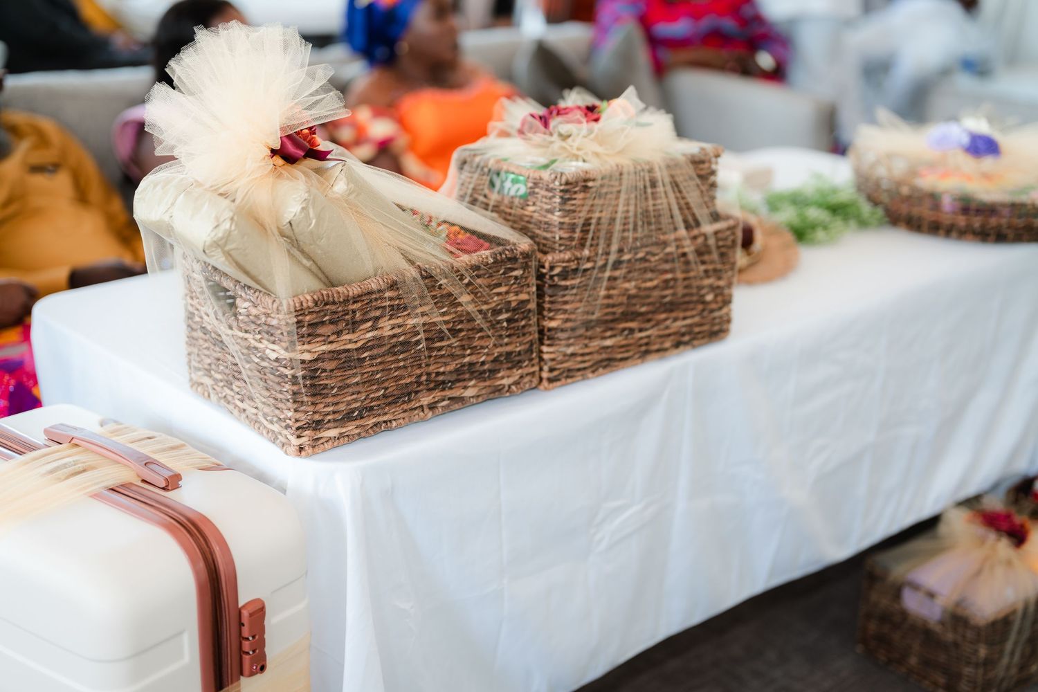 Traditional decorative items arranged on a white tablecloth at a cultural celebration.
