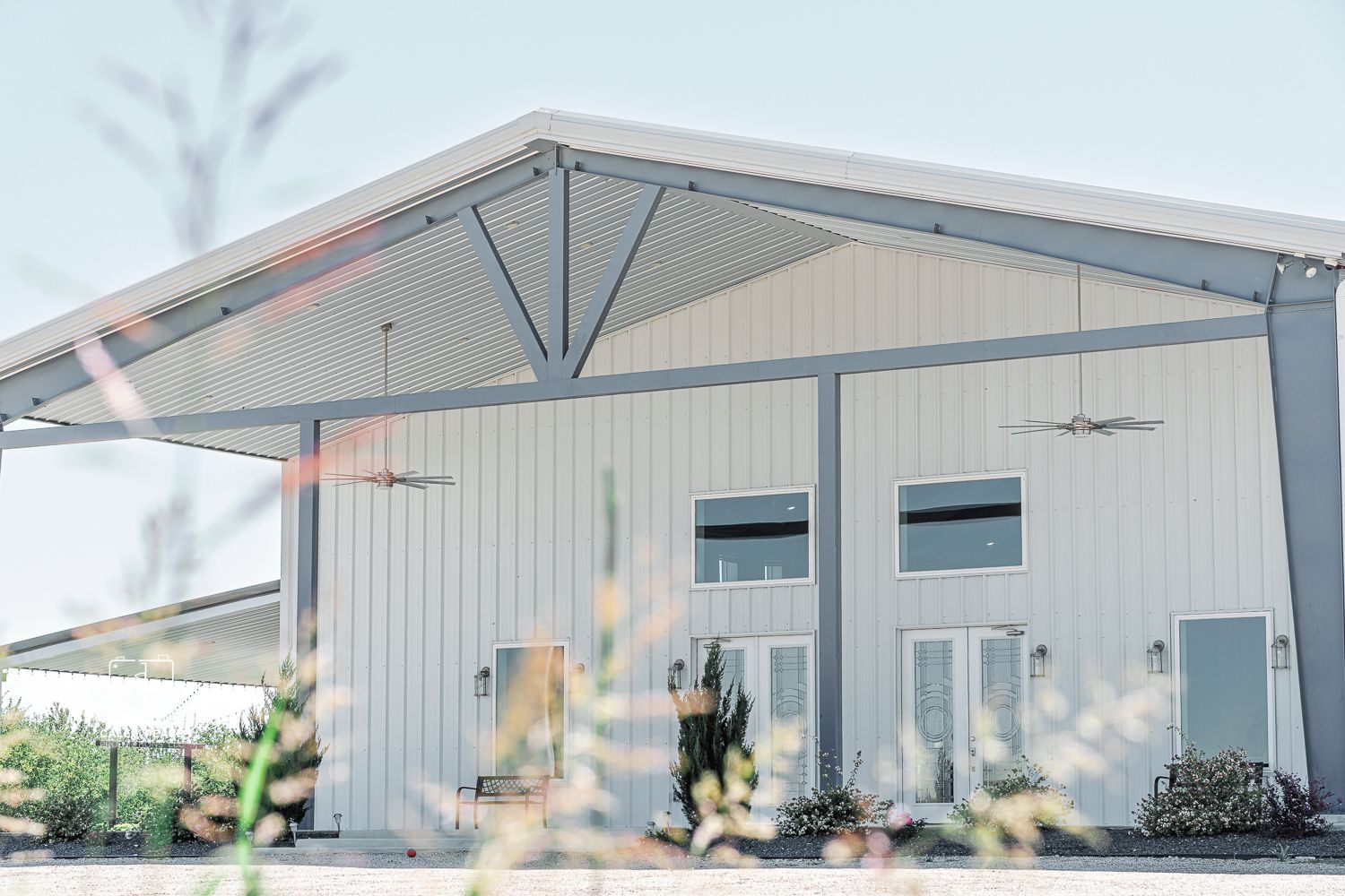 Modern white industrial wedding venue exterior with clean architectural lines.
