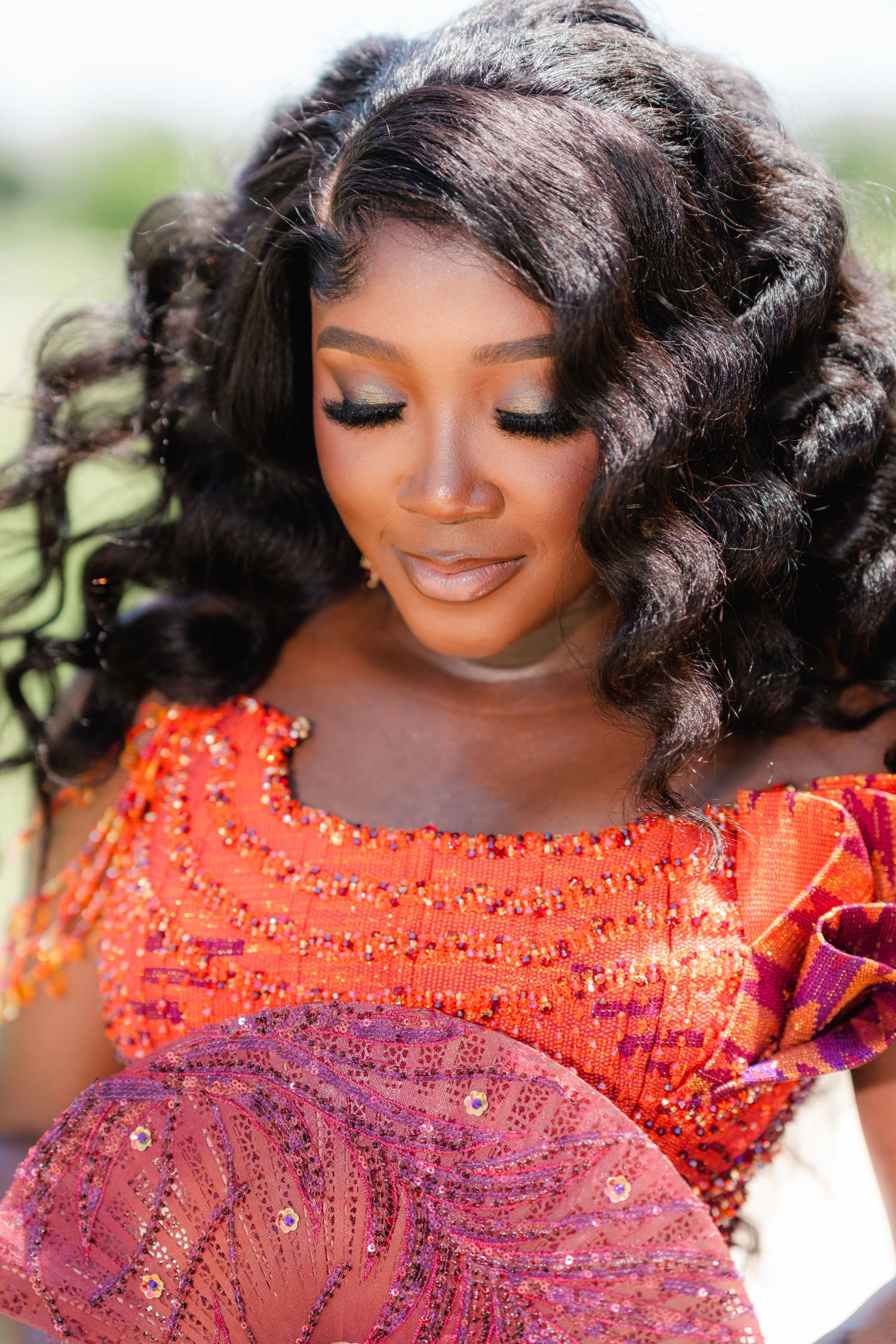 Close-up details of orange and purple beaded formal dress.