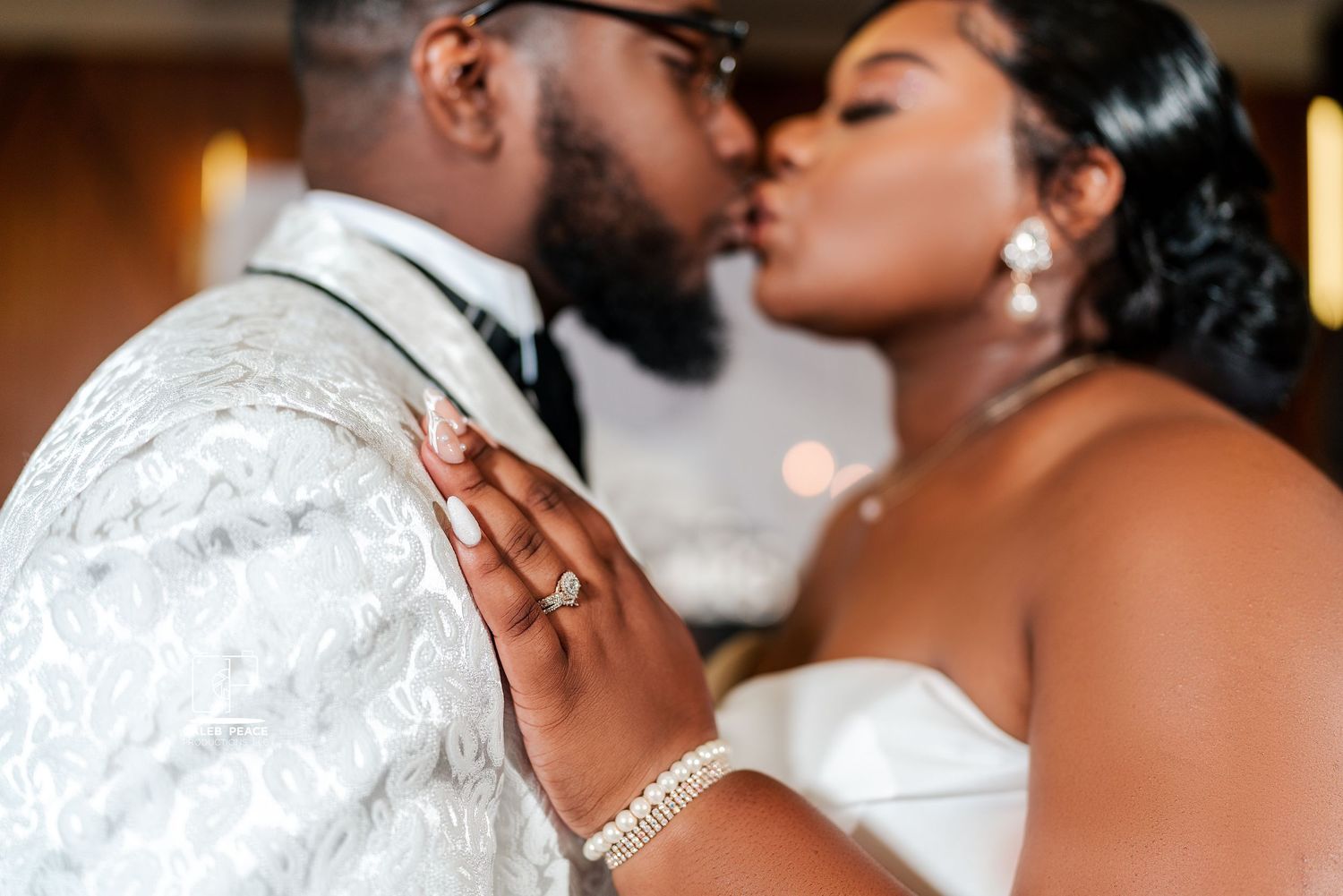 Intimate romantic moment captured between a couple during their wedding celebration with soft lighting and elegant attire.