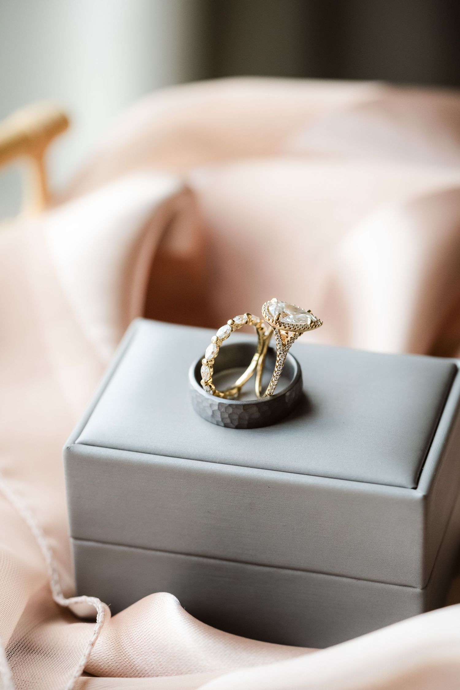 Diamond engagement ring rests elegantly in a gray jewelry box.