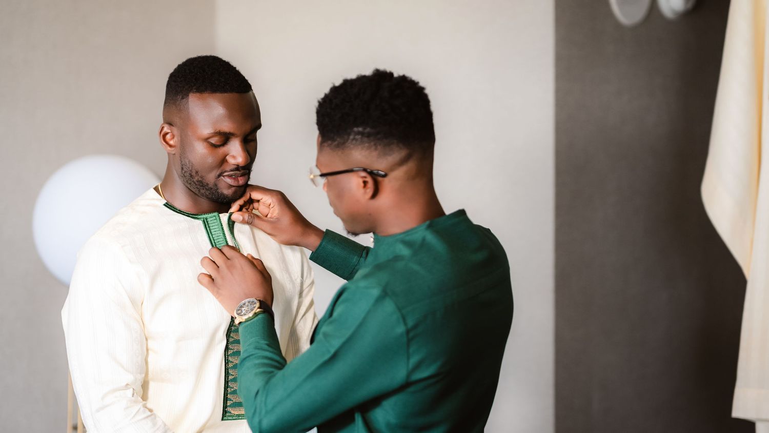A couple in coordinating green and white outfits embrace lovingly in a series of romantic poses.