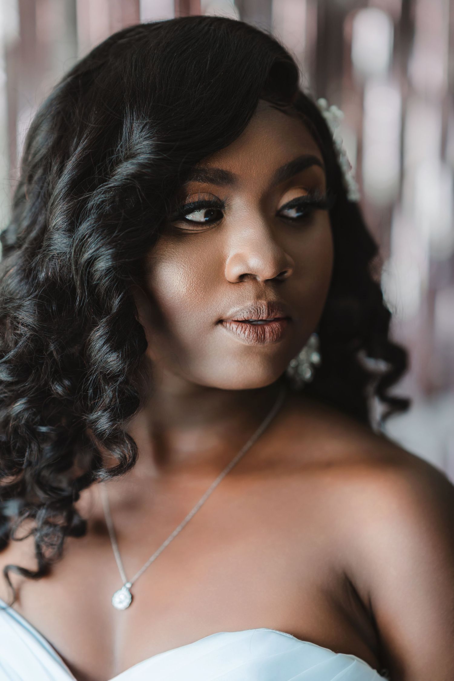 Artistic bridal portrait series with soft lighting and elegant jewelry.