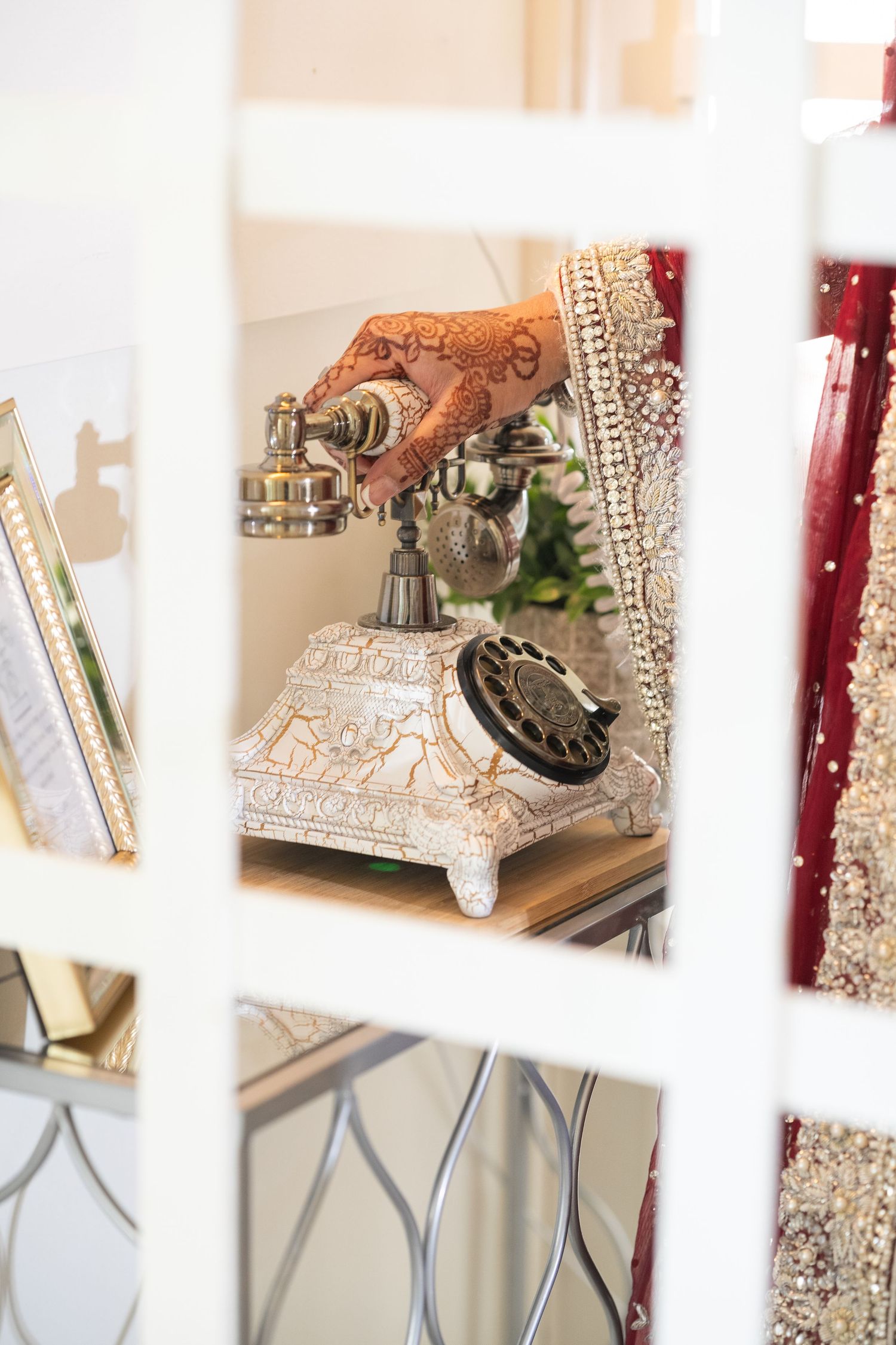 Decorative wedding display featuring ornate silver and gold accessories on white shelving units.