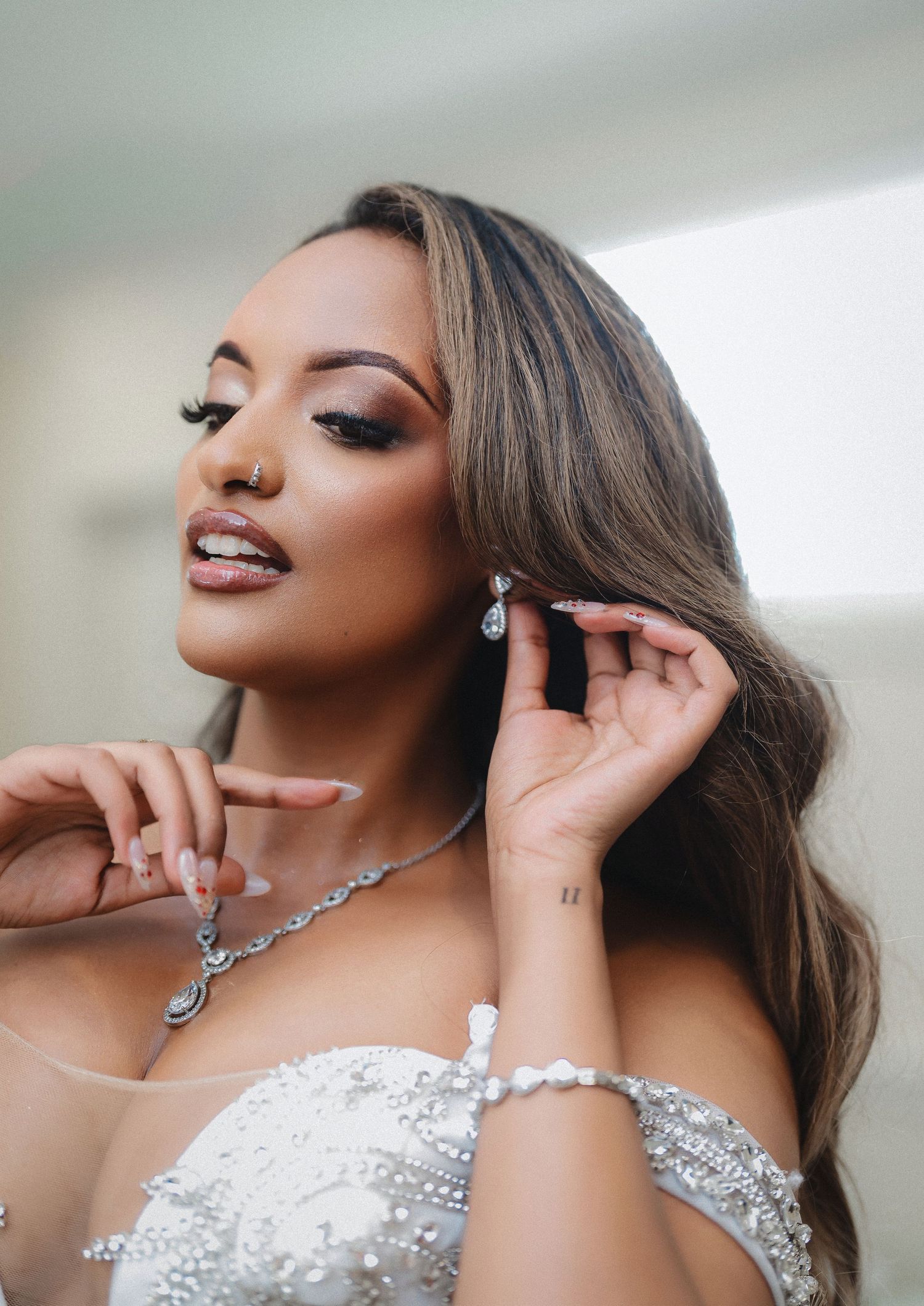A close-up bridal portrait showcasing glamorous makeup and sparkling jewelry.