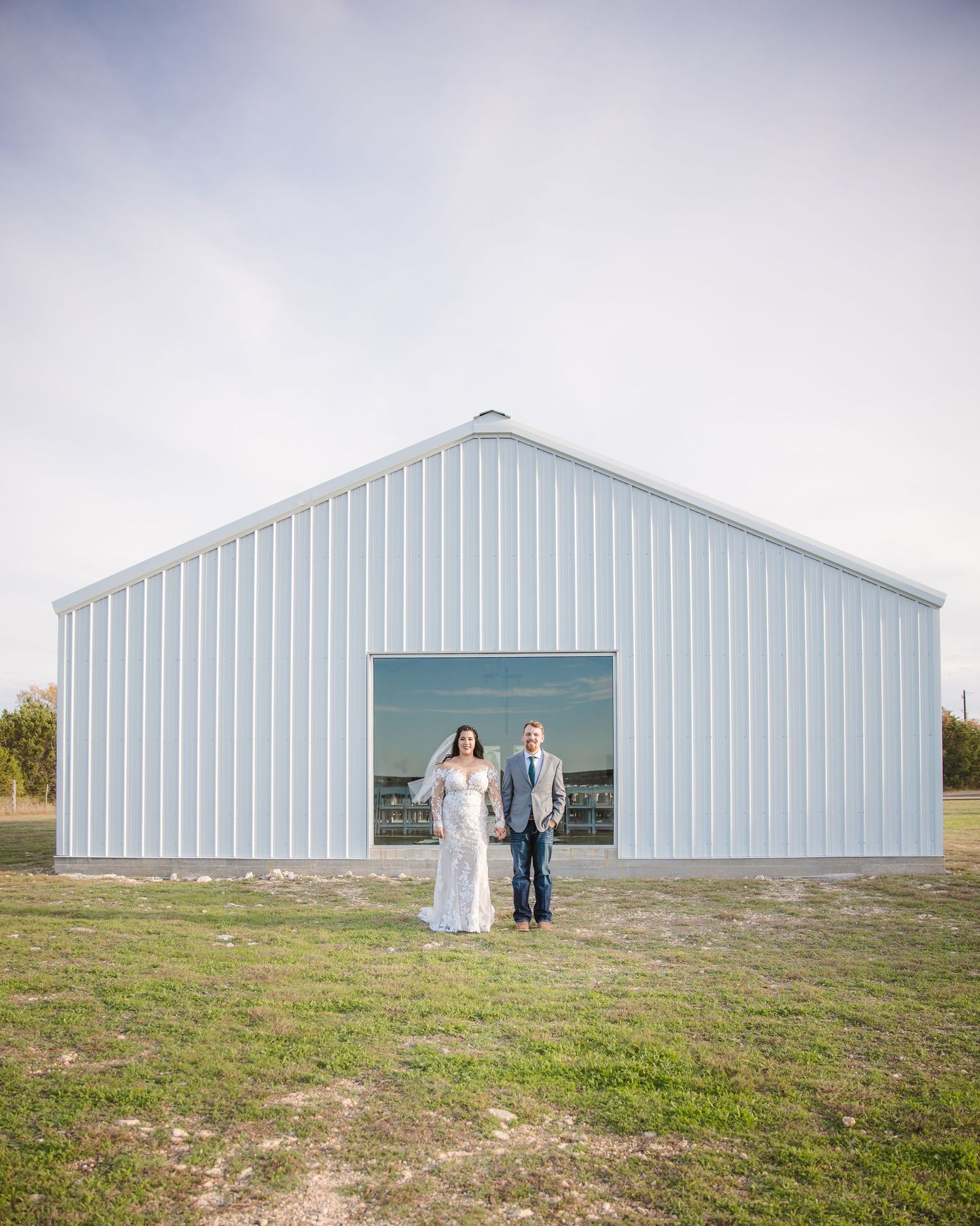 A series of wedding photos showing a couple walking in front of a large white barn building.